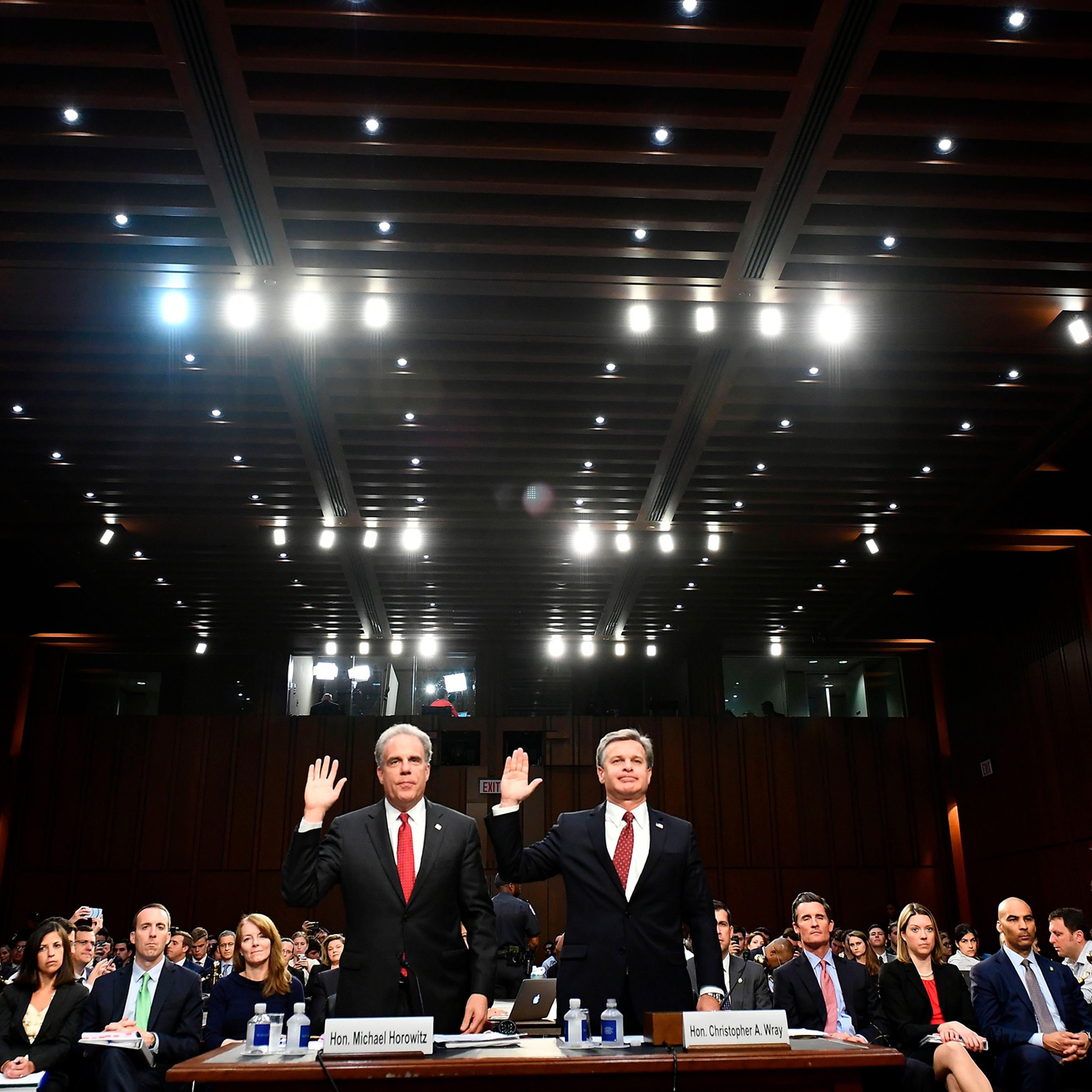 Justice Department Inspector General Michael Horowitz, left, and FBI Director Christopher Wray take an oath before testifying to the Senate Judiciary Committee in Washington, DC on June 18, 2018.