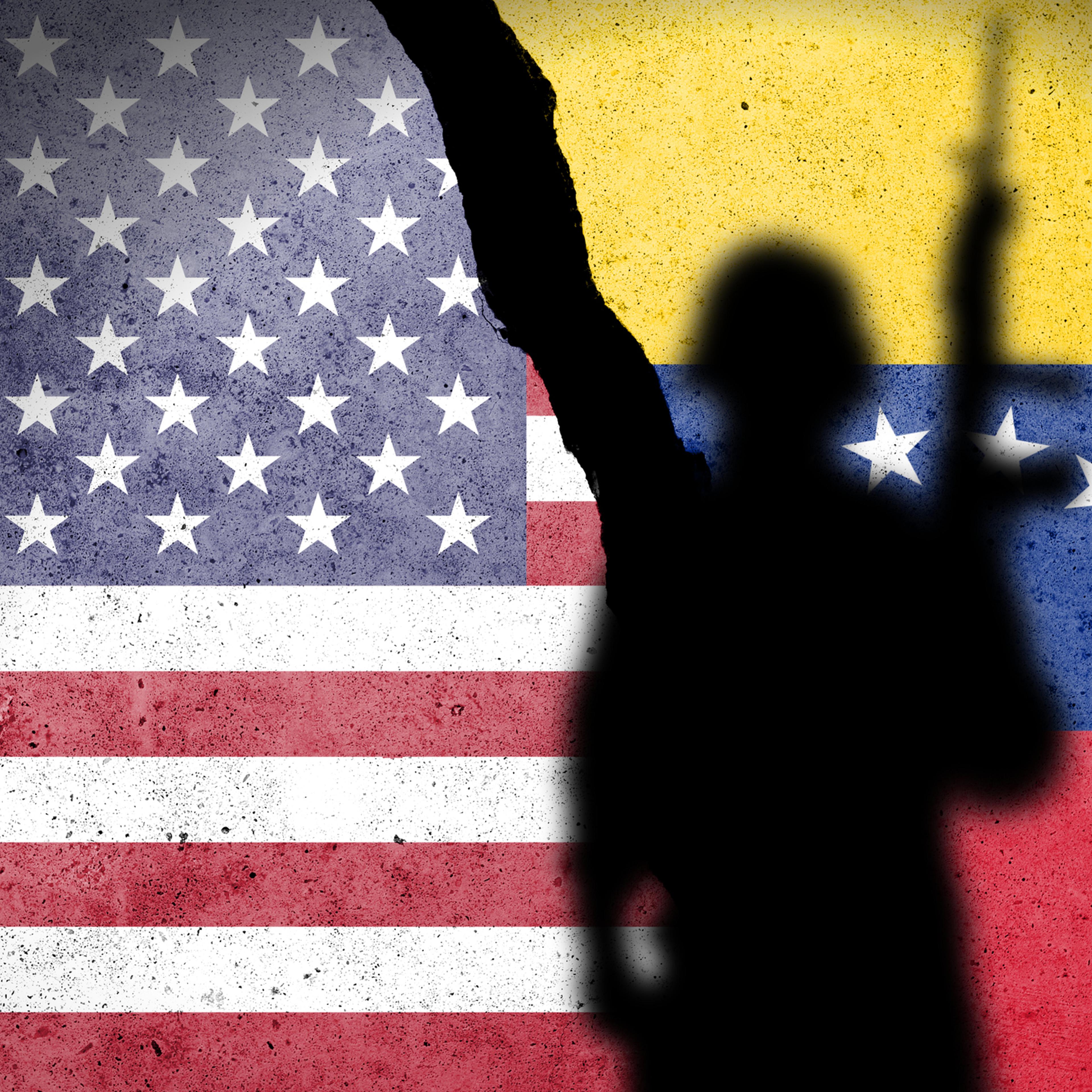 Flag of USA and Venezuela painted on a concrete wall with soldiers shadow