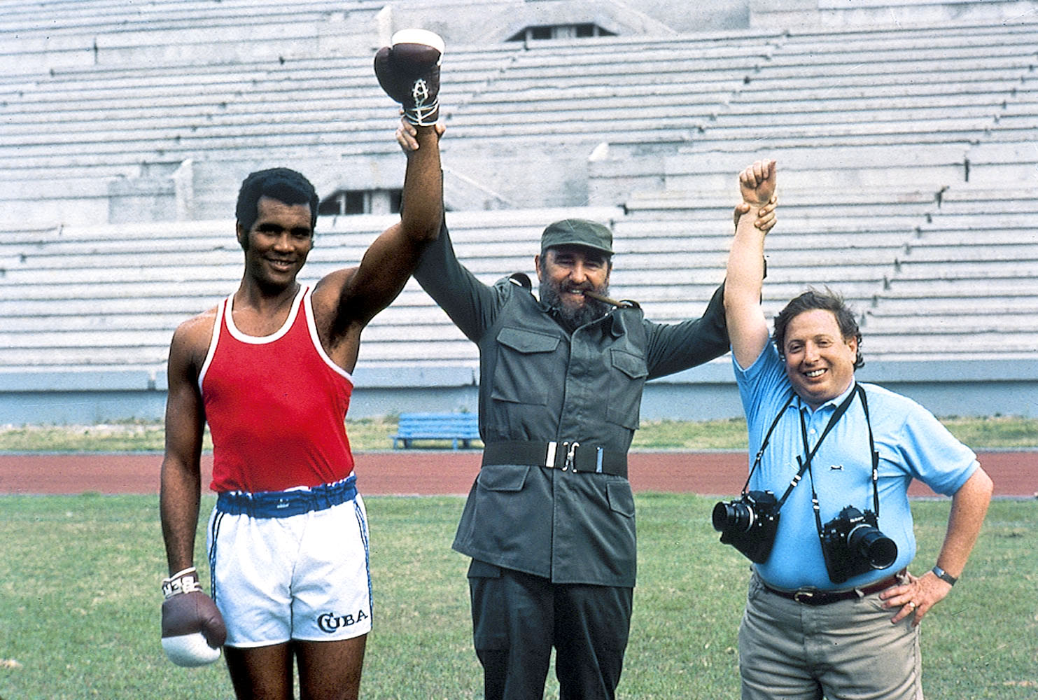 Cuba</br>Photographer Neil Leifer (right) poses with Fidel Castro and Cuban heavyweight boxer Teofilo Stevenson while on assignment.