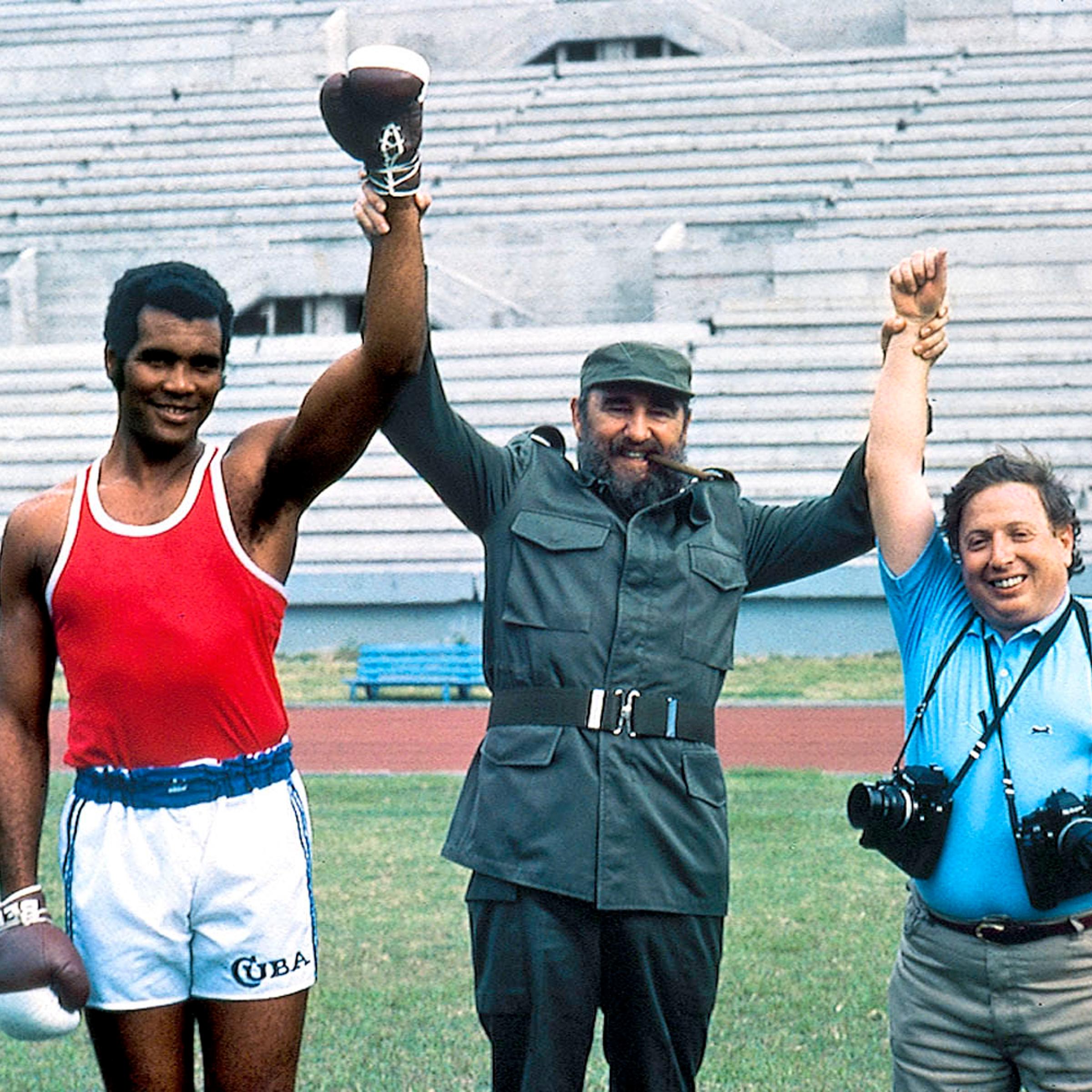 Cuba</br>Photographer Neil Leifer (right) poses with Fidel Castro and Cuban heavyweight boxer Teofilo Stevenson while on assignment.