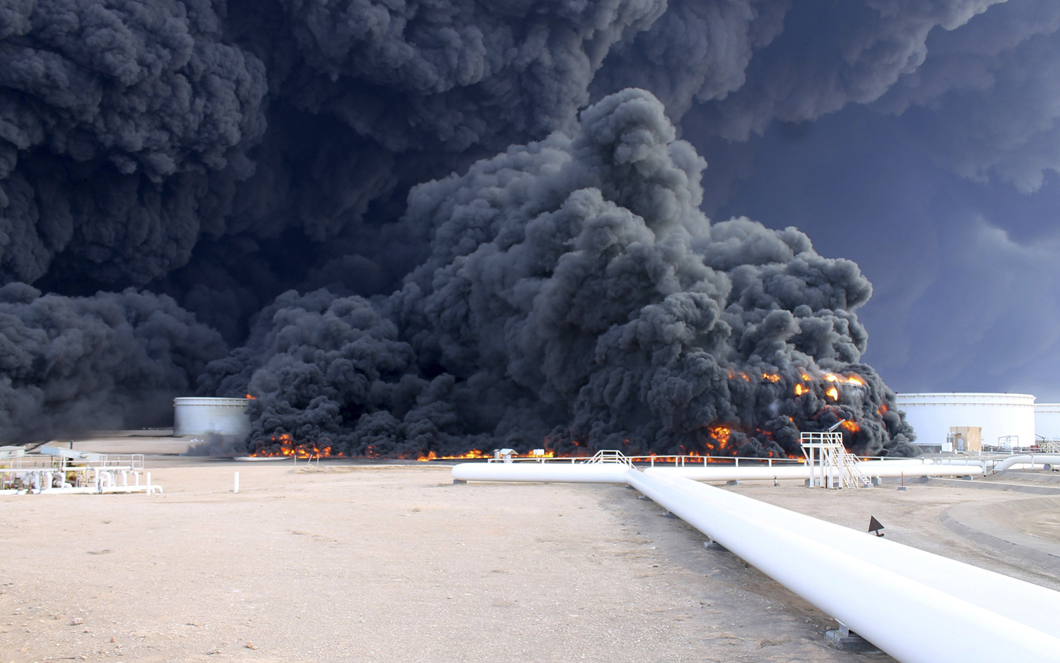 Smoke rises from an oil tank fire in Es Sider port