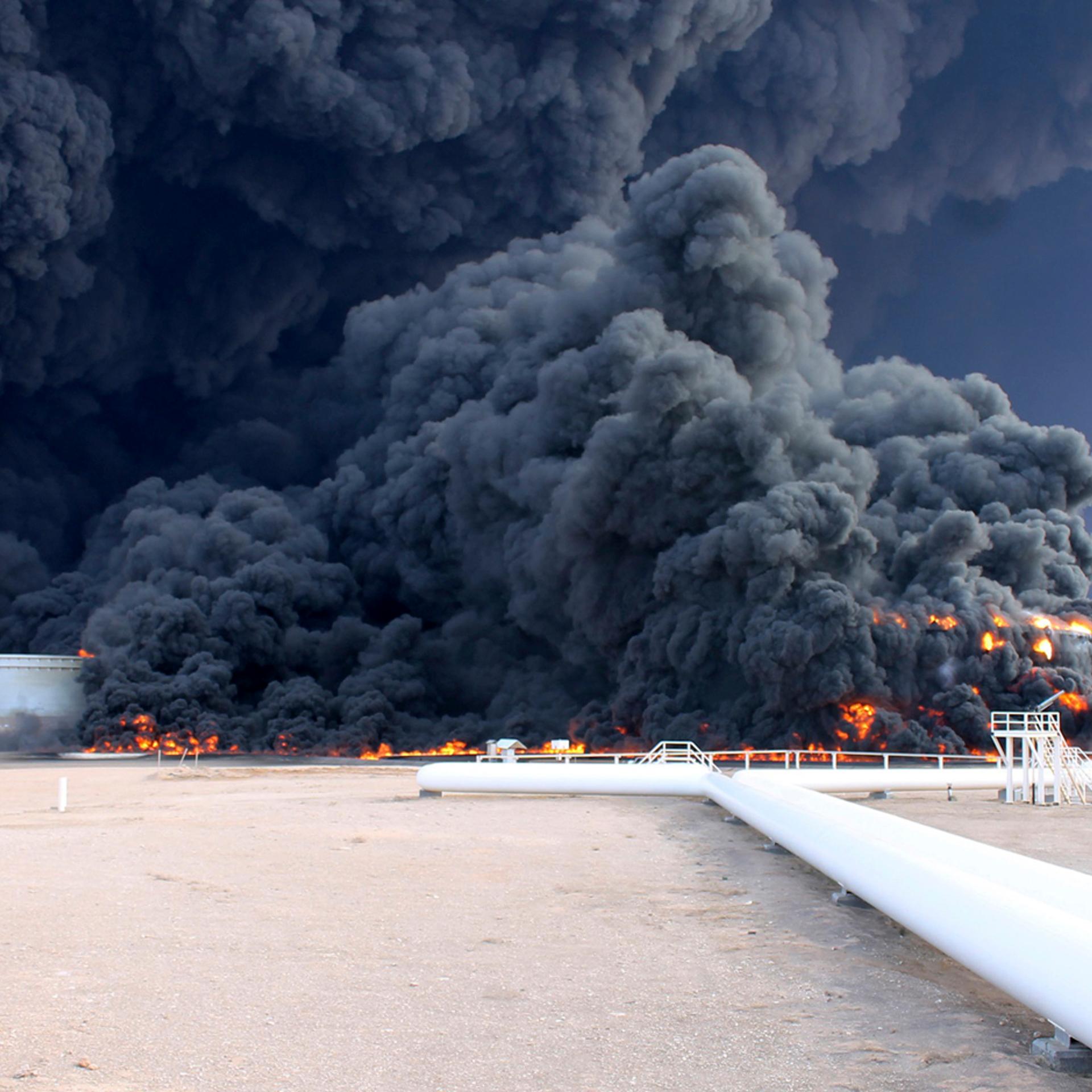 Smoke rises from an oil tank fire in Es Sider port