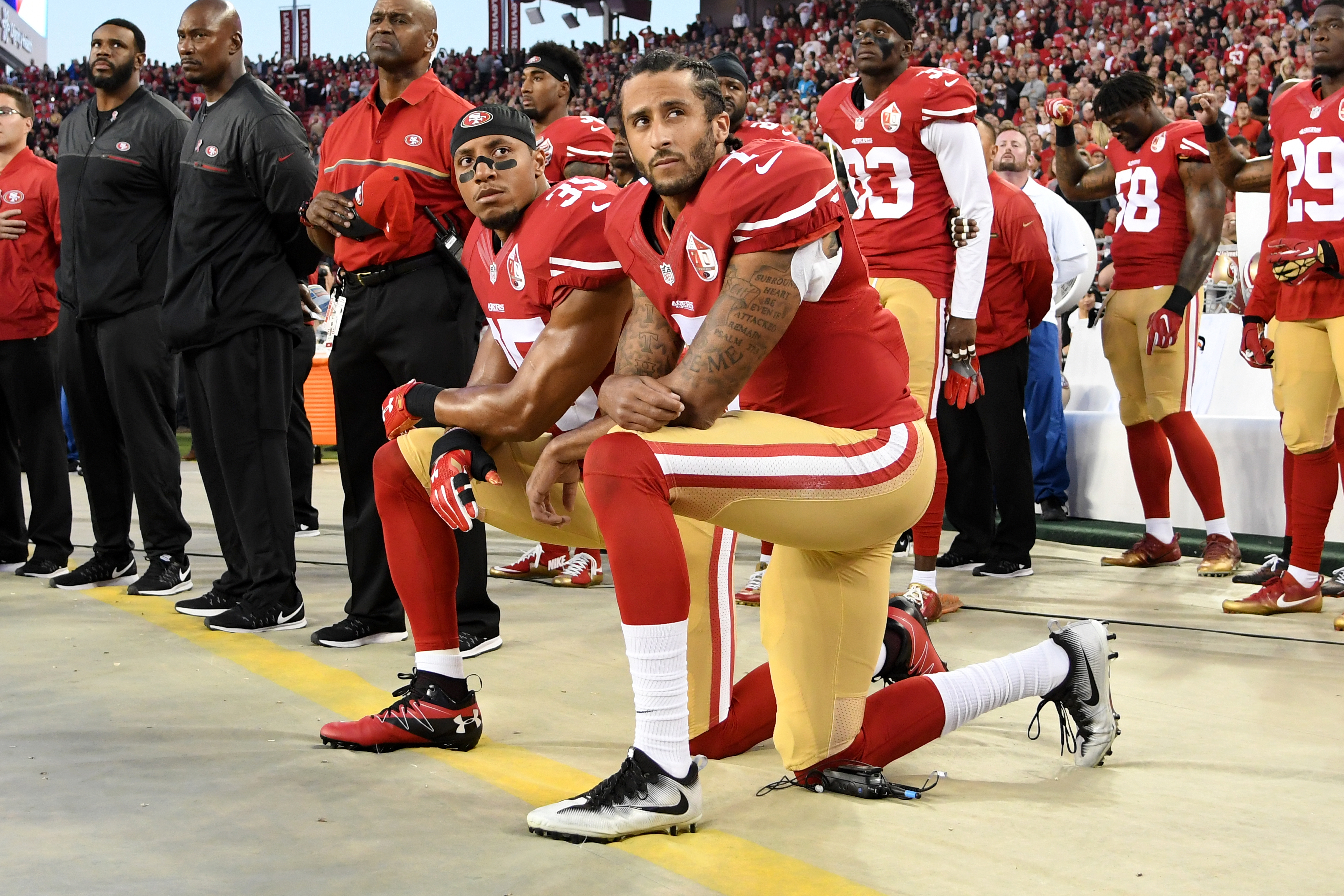 Colin Kaepernick #7 and Eric Reid #35 of the San Francisco 49ers kneel in protest during the national anthem prior to playing the Los Angeles Rams in their NFL game at Levi's Stadium in Santa Clara, Calif., on Sept. 12, 2016.