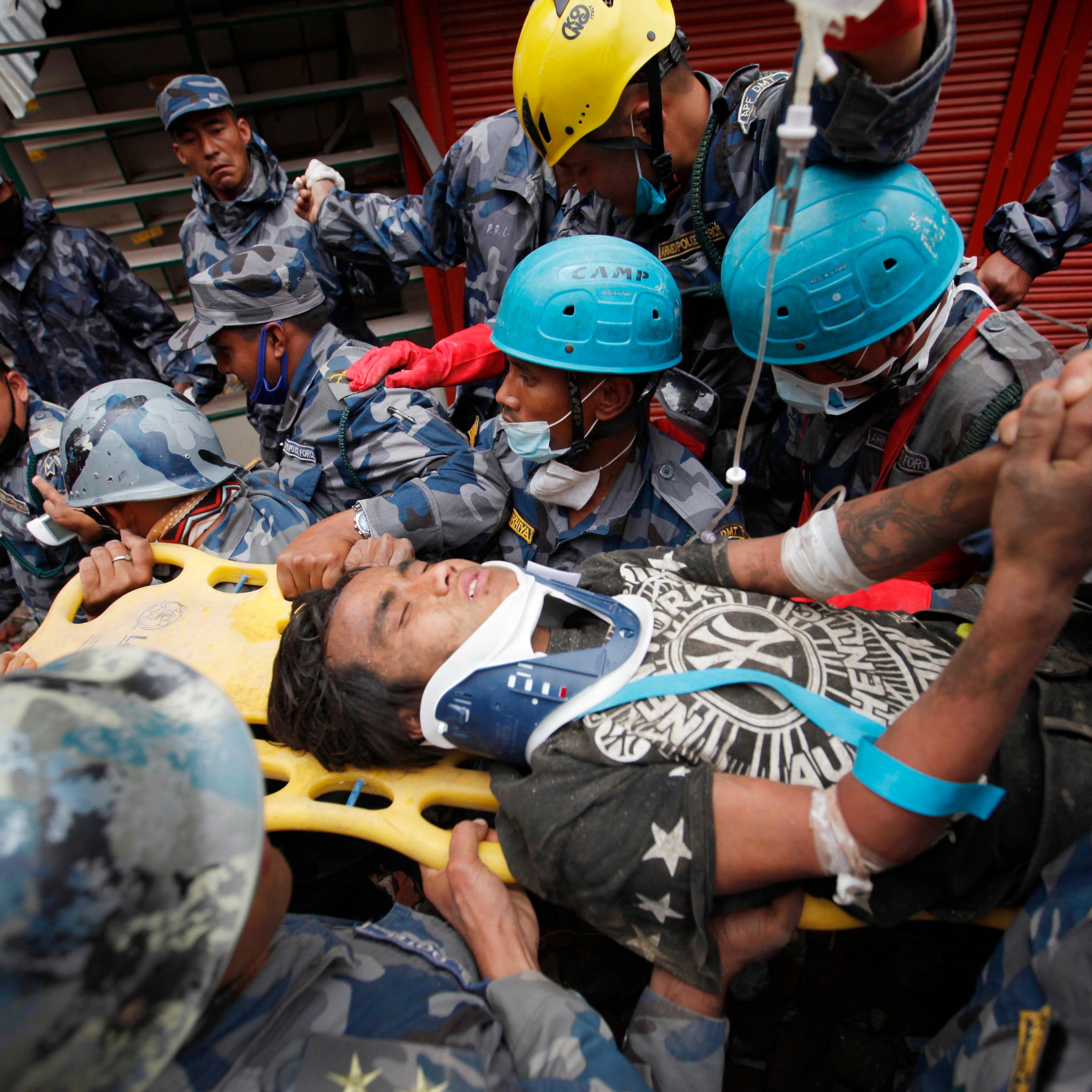 Pemba Tamang is carried on a stretcher after being rescued by Nepalese policemen and U.S. rescue workers from a building that collapsed five days ago in Kathmandu, Nepal on April 30, 2015.