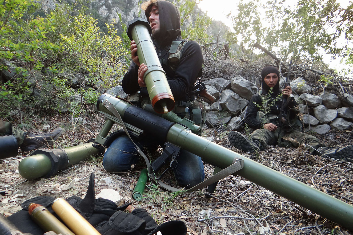 A rebel fighter checks a launcher near the village of Kessab and the border crossing with Turkey, in the northwestern province of Latakia, on March 23, 2014. Rebels seized Kessab a day later.