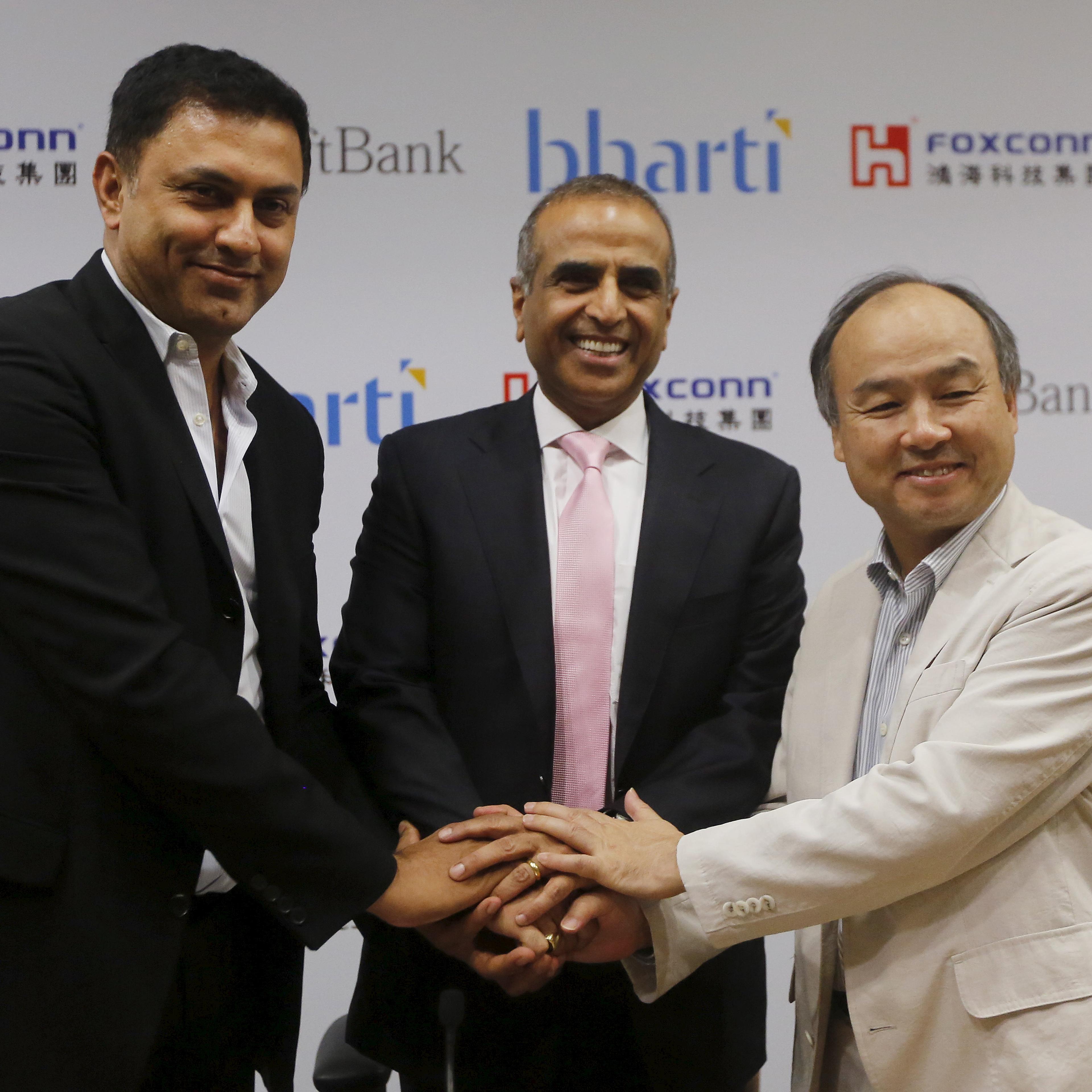 Son, founder and chief executive officer of Japan's SoftBank Corp., Arora, president of SoftBank Corp. and Mittal, chairman of Bharti Enterprises, shake hands before the start of a news conference in New Delhi