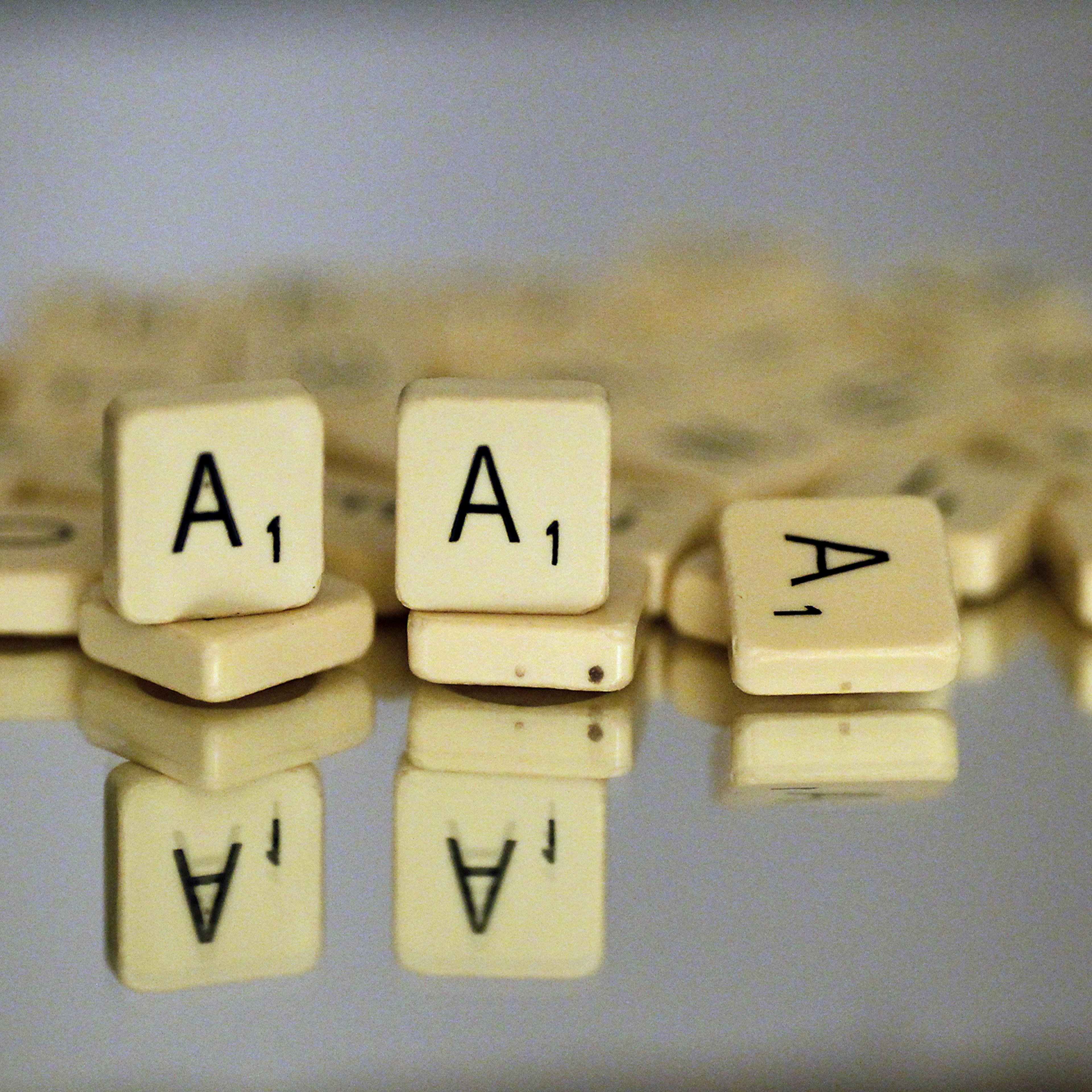 Scrabble "A" lettered tiles are displaye
