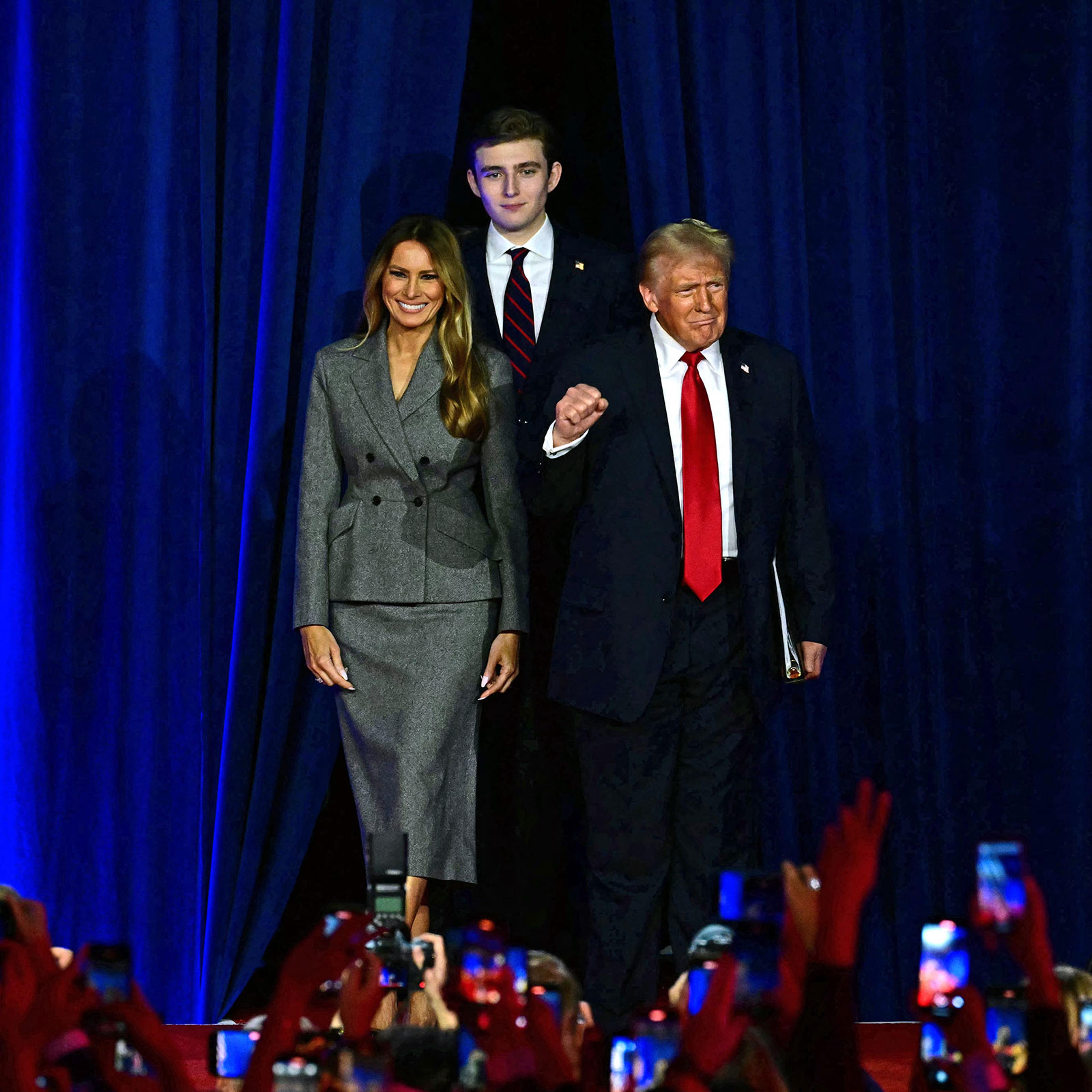 Former US President and Republican presidential candidate Donald Trump arrives for an election night event alongside former US First Lady Melania Trump and his son Barron Trump at the West Palm Beach Convention Center in West Palm Beach, Fla, on Nov. 6, 2024.
