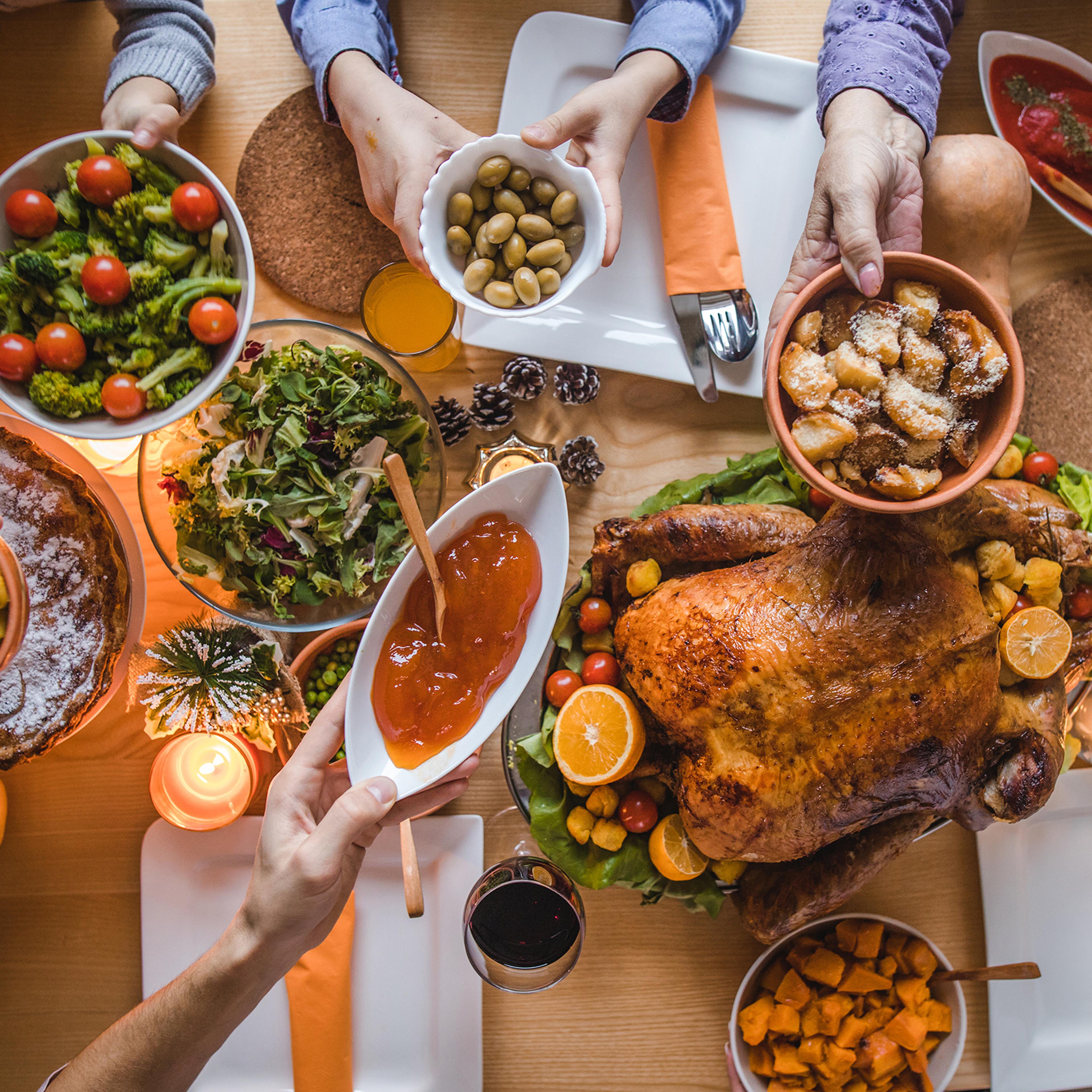 Above view of passing food during Thanksgiving dinner.