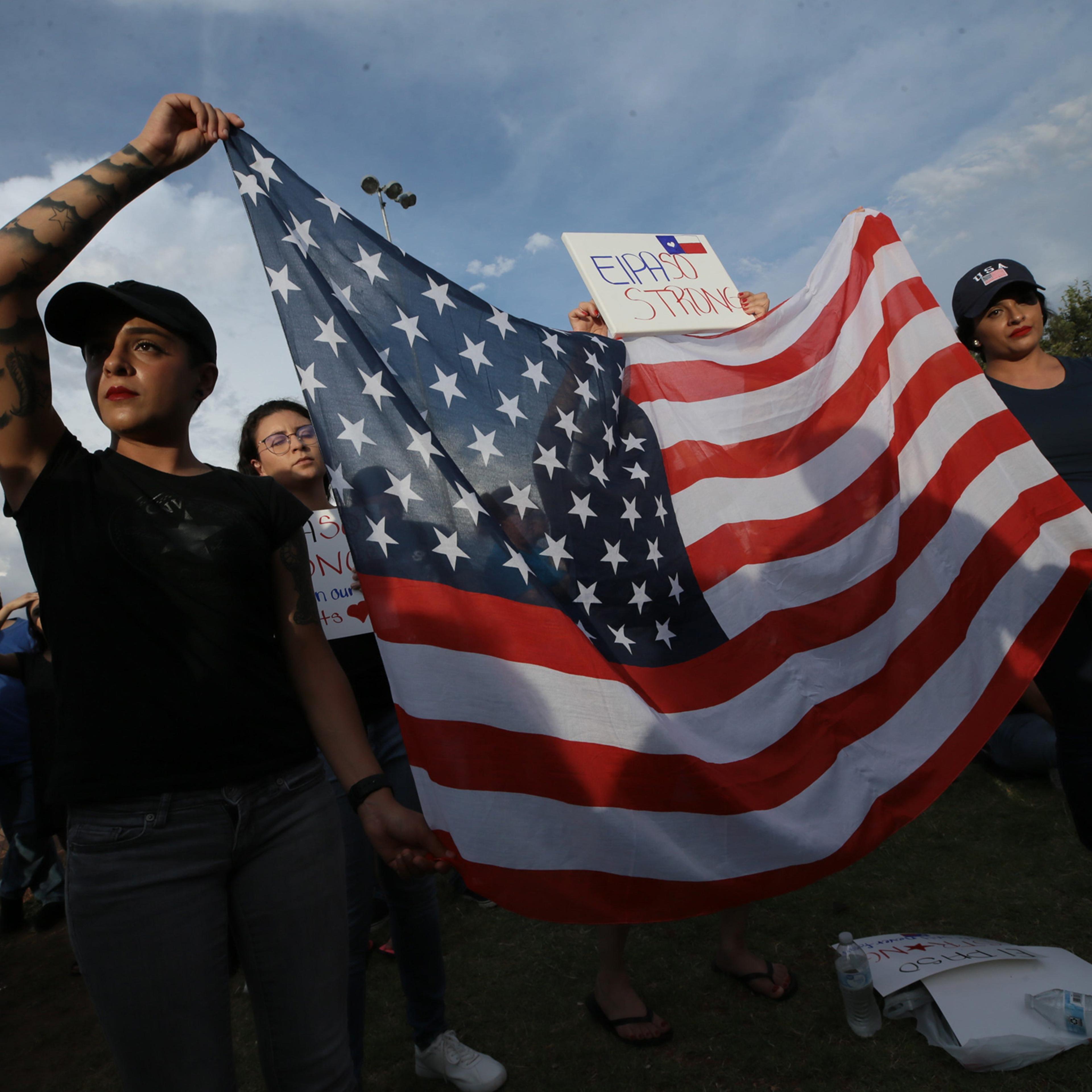 Danielle Novoa, right, with her twin sister Jessica Torres at an interfaith vigil in El Paso’s Ponder Park on Aug. 4.