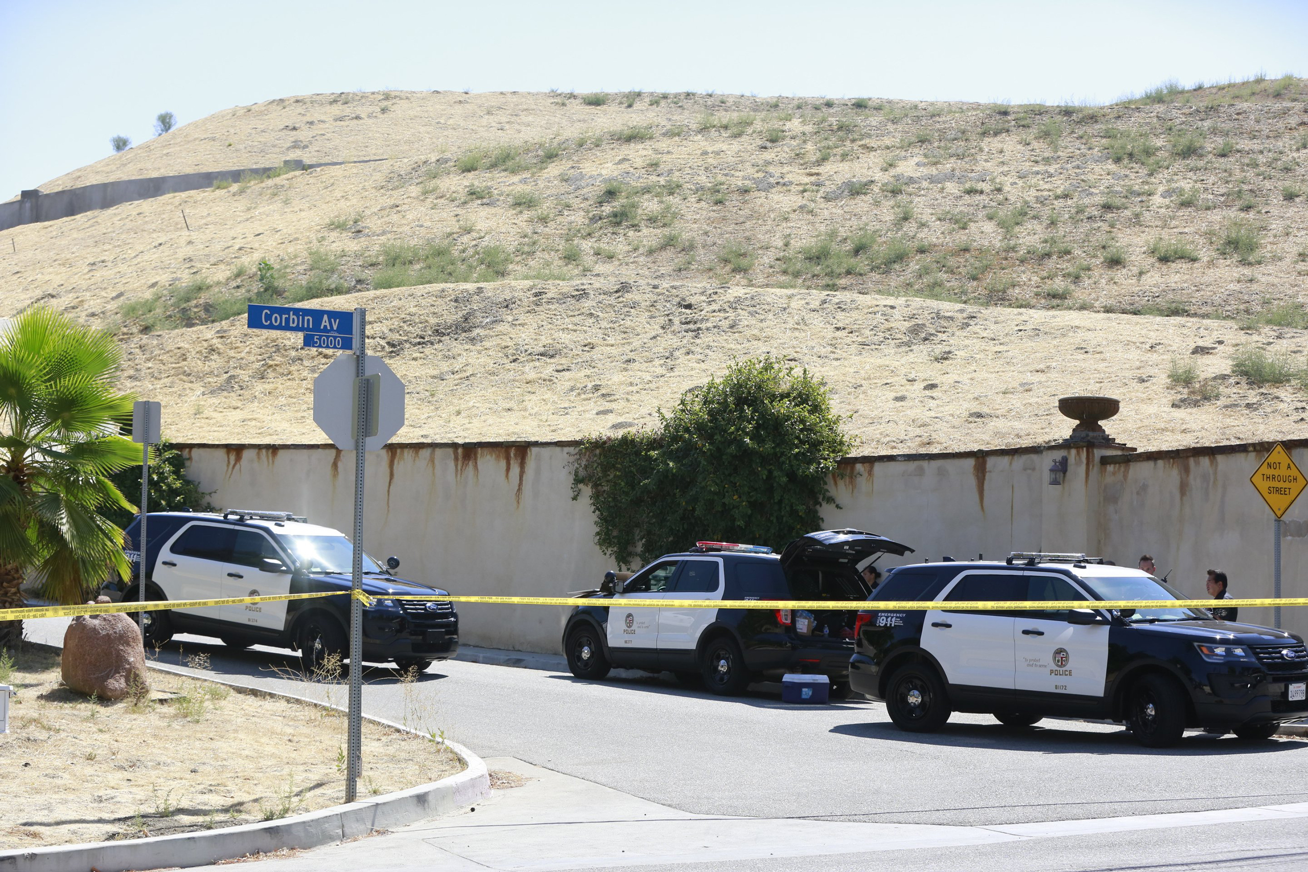 Los Angeles Police patrol the entrance to the street of singer Chris Brown's home in the Tarzana neighborhood of Los Angeles, Aug. 30, 2016.
