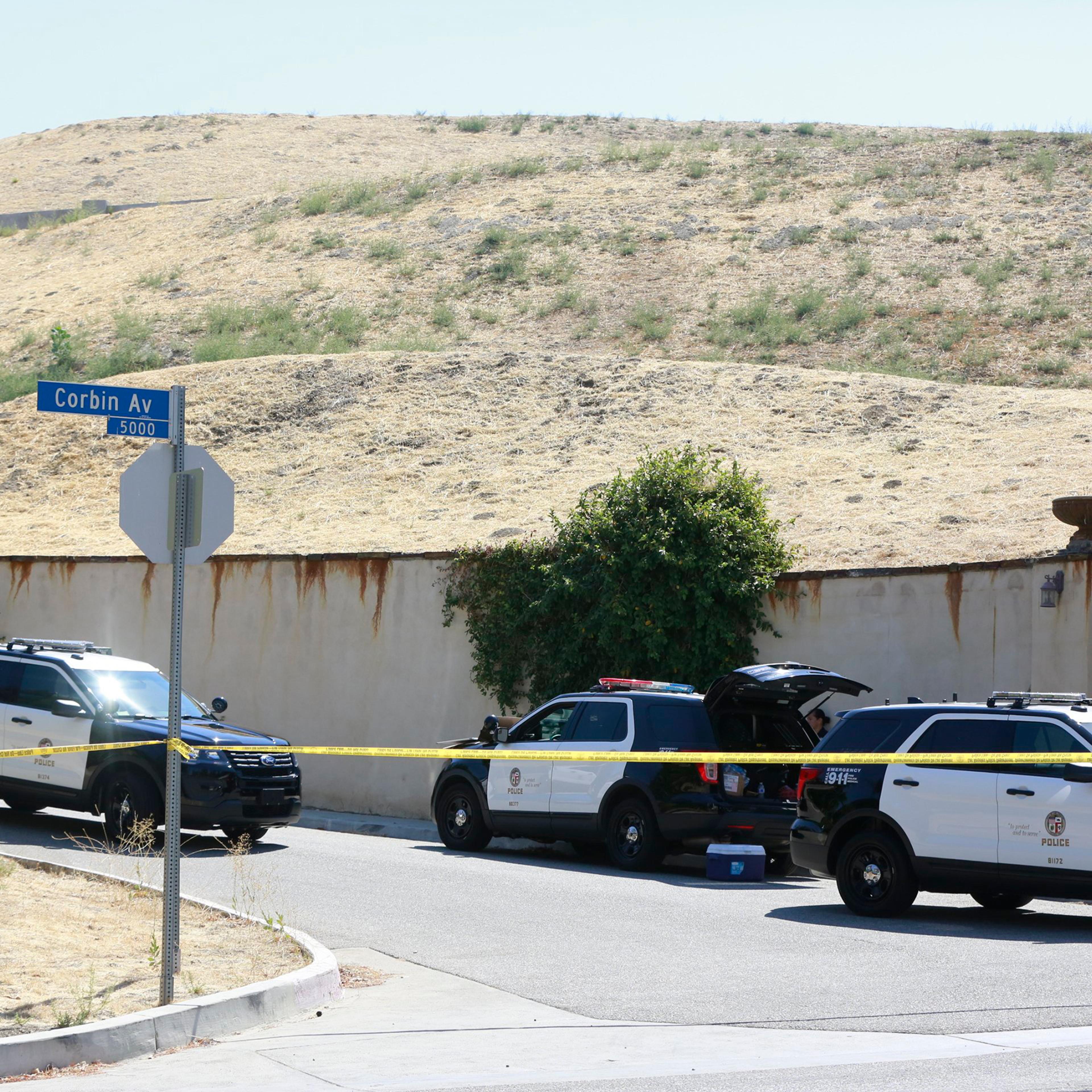 Los Angeles Police patrol the entrance to the street of singer Chris Brown's home in the Tarzana neighborhood of Los Angeles, Aug. 30, 2016.