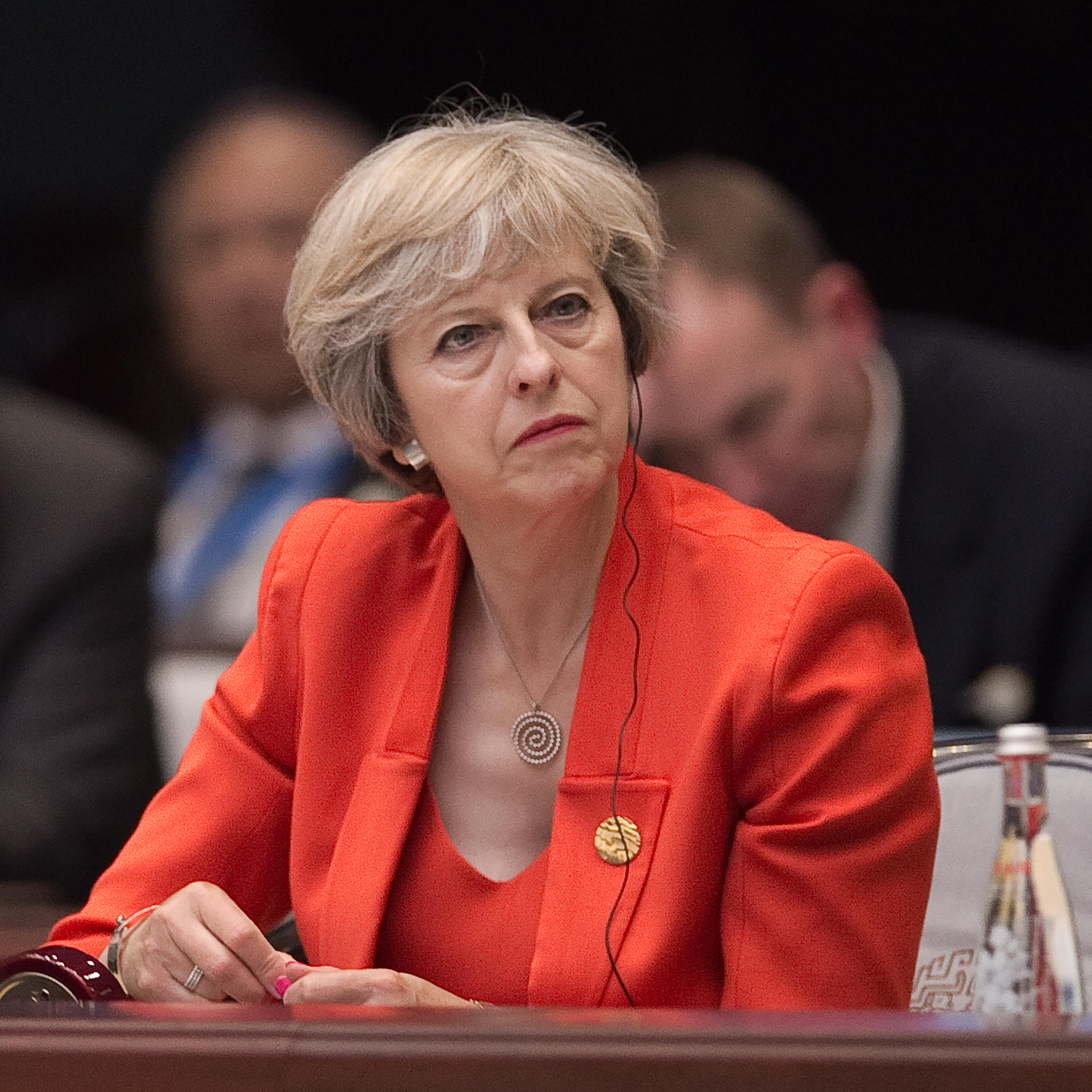 Britain's Prime Minister Theresa May listens to Chinese President Xi Jinping speech during the opening ceremony of the G20 Leaders Summit on September 4, 2016 in Hangzhou, China.
