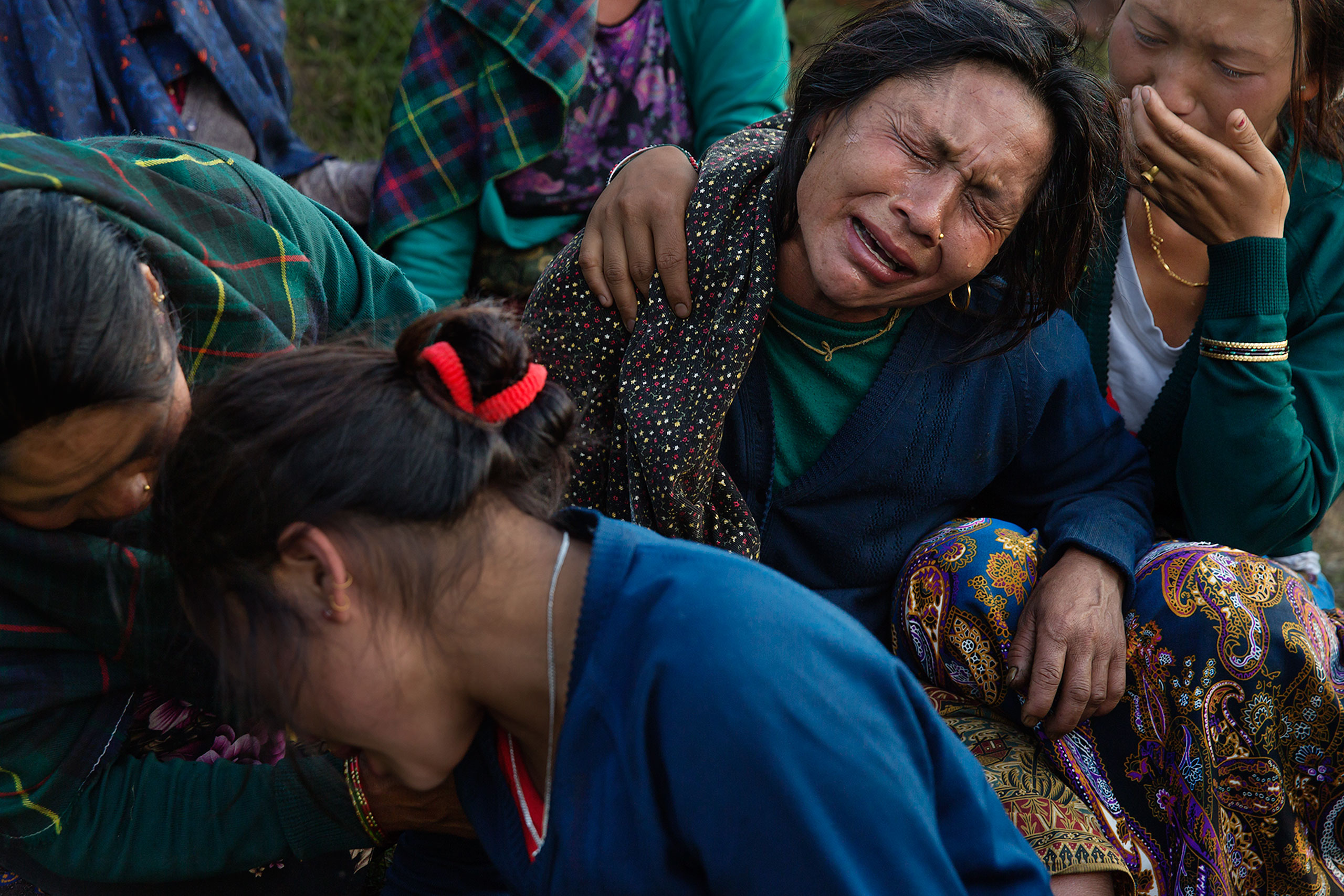 Nepal earthquake. Barpak, the epicenter of the earthquake. Funeral of Pur Bahadur Gurung, 26, who had just been dug out of the rubble. Saainli Gurung, his mother weeping. Scenes of villagers salvaging building materials and personal possessions. Dhan Raj