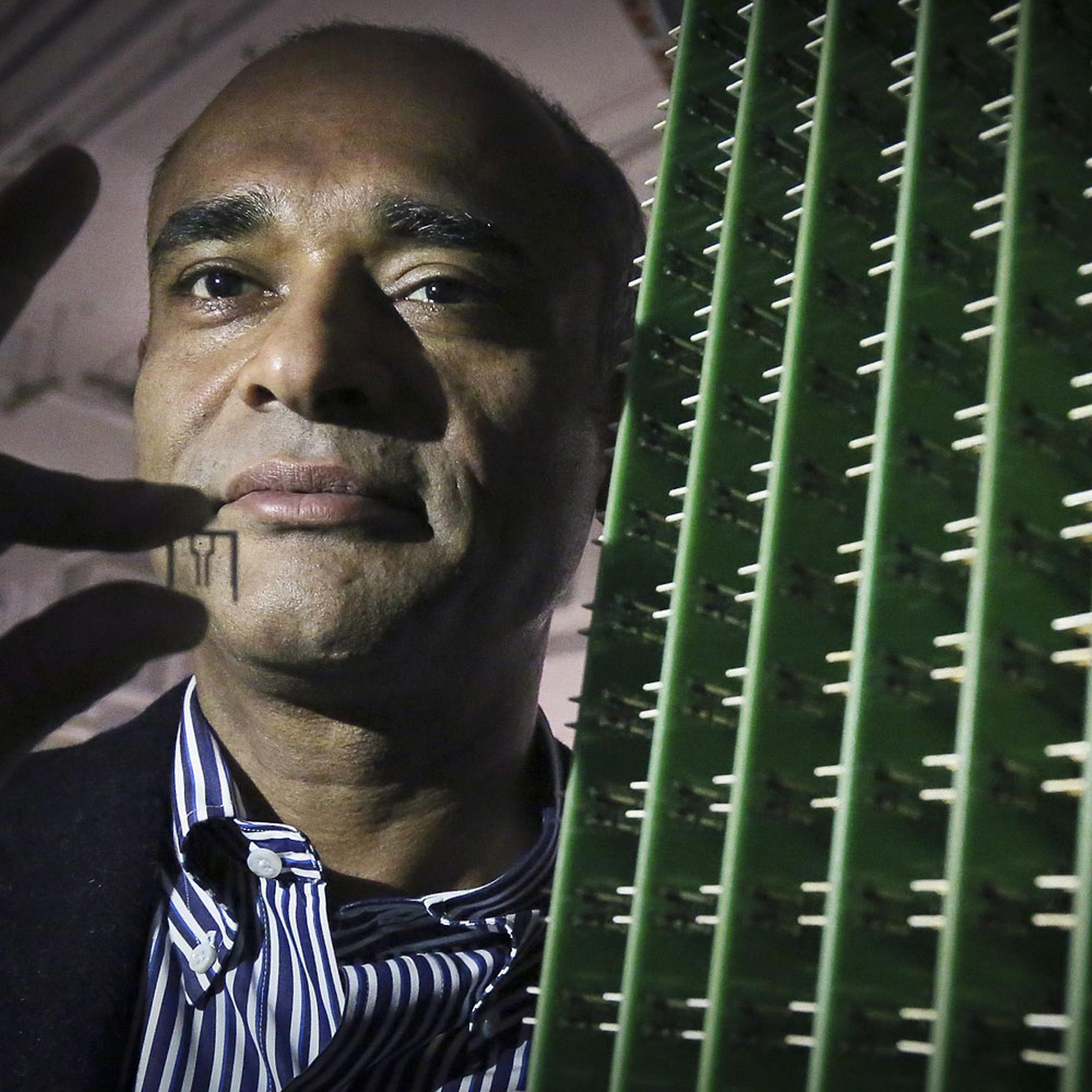 Chet Kanojia, founder and CEO of Aereo, Inc., stands next to a server array of antennas in New York, Dec. 20, 2012.