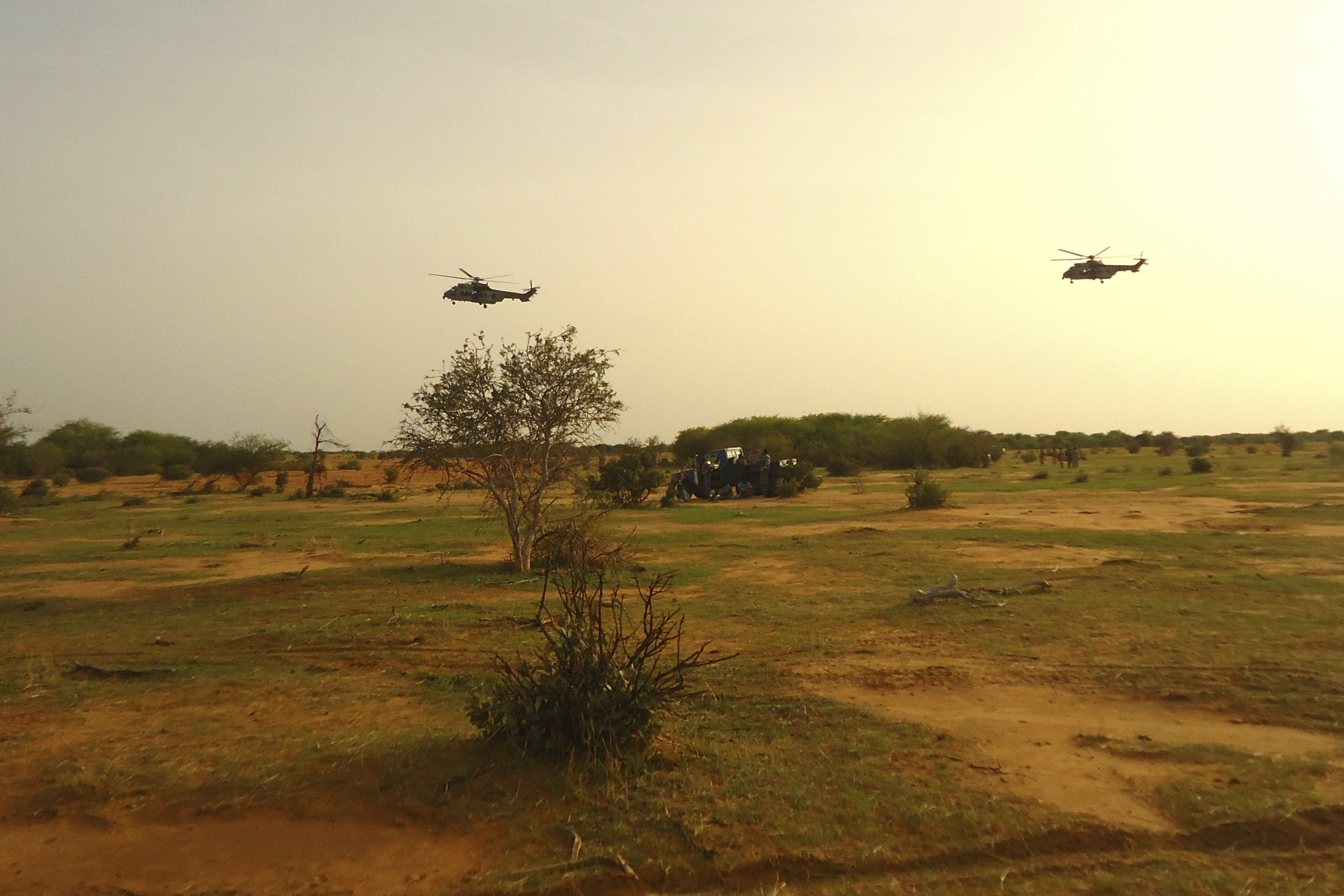 French military helicopters fly above the crash site of Air Algerie flight AH5017 near the northern Mali town of Gossi