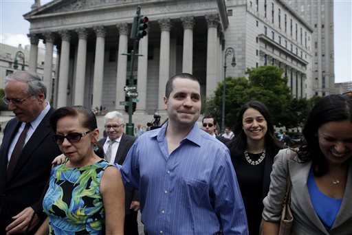 GIlberto Valle, center, leaves Manhattan federal court in New York on Tuesday, July 1, 2014.