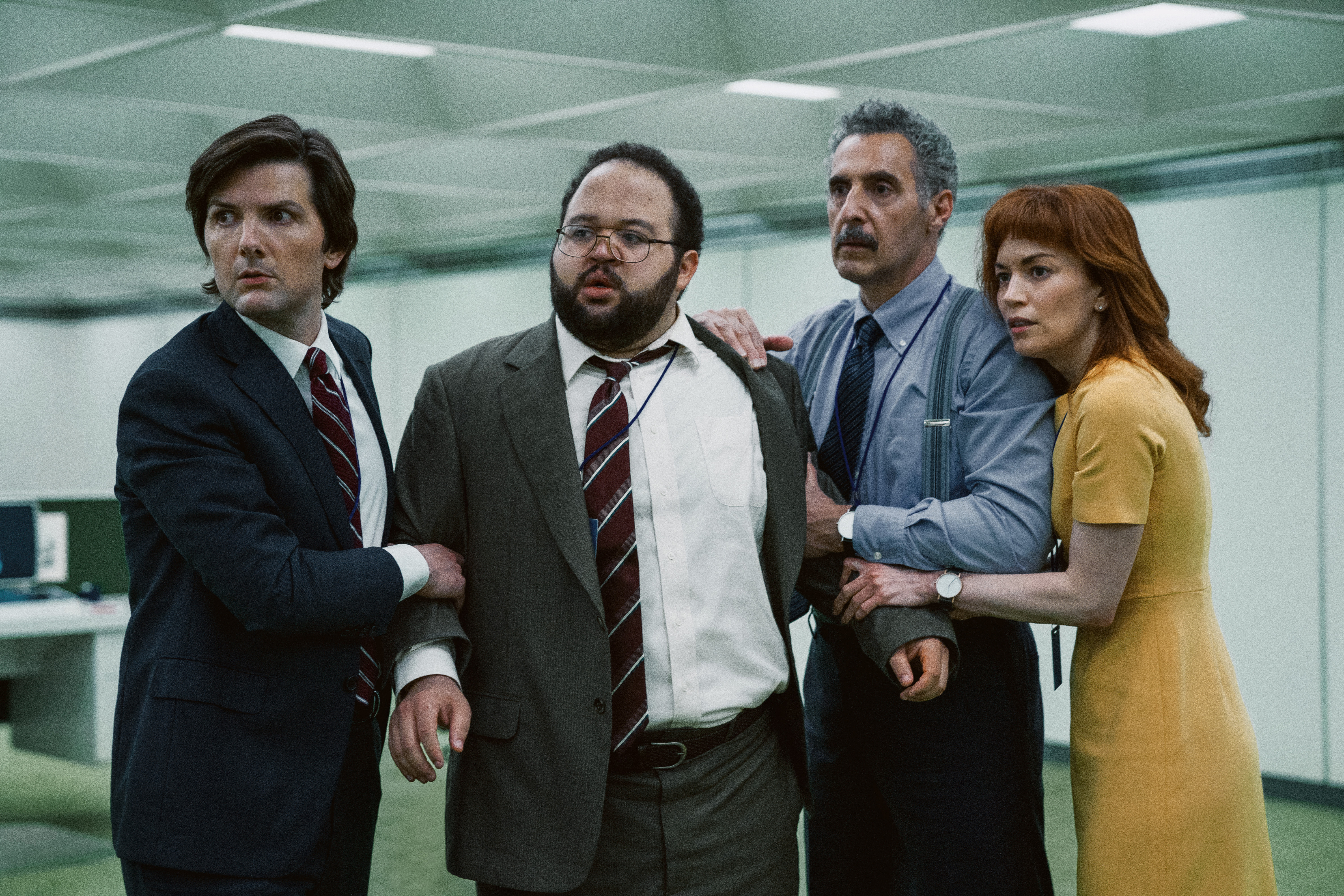 (L-R) Adam Scott, Zach Cherry, John Turturro, and Britt Lower in <i>Severance</i>