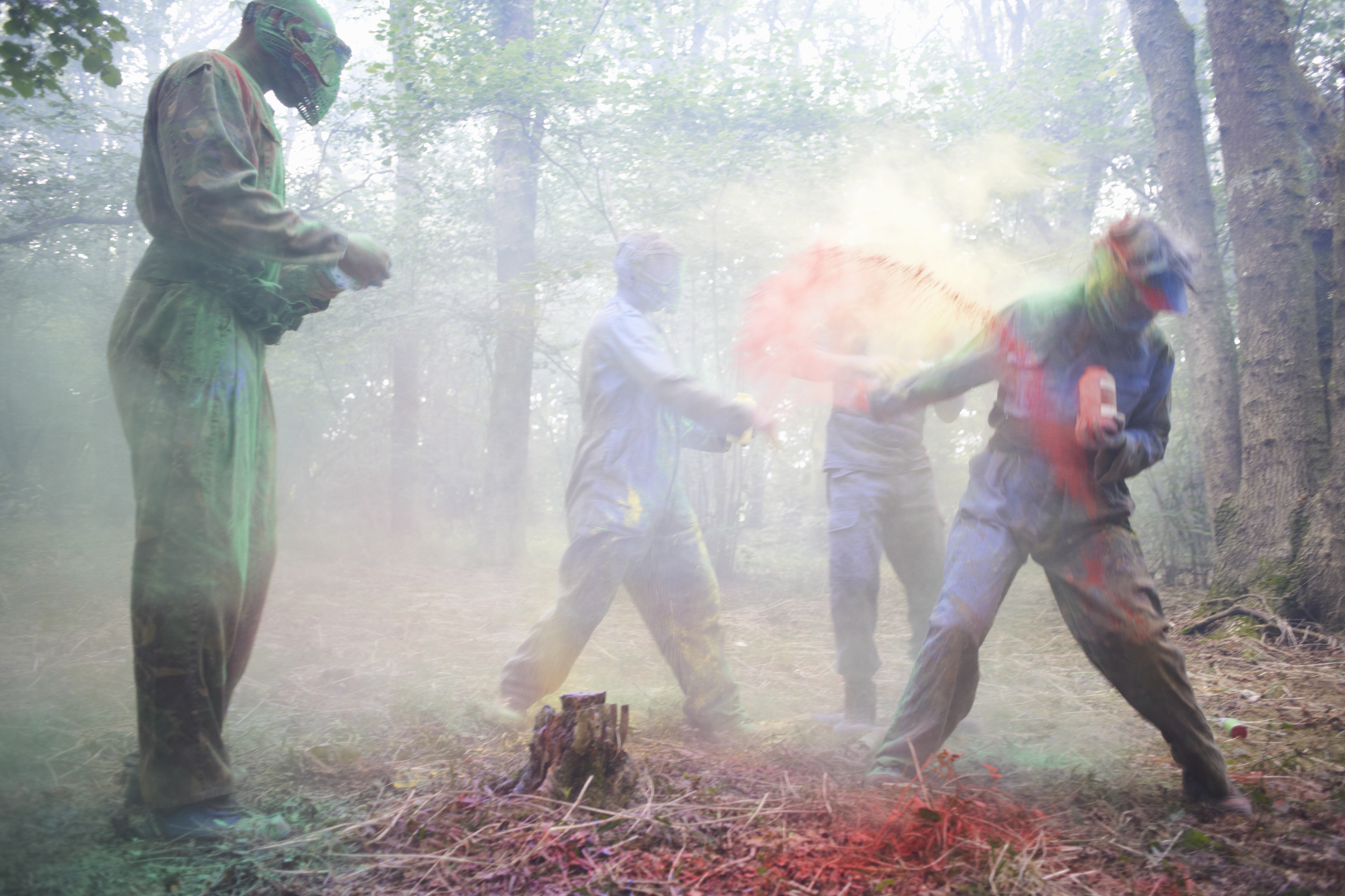 Paintball players in action