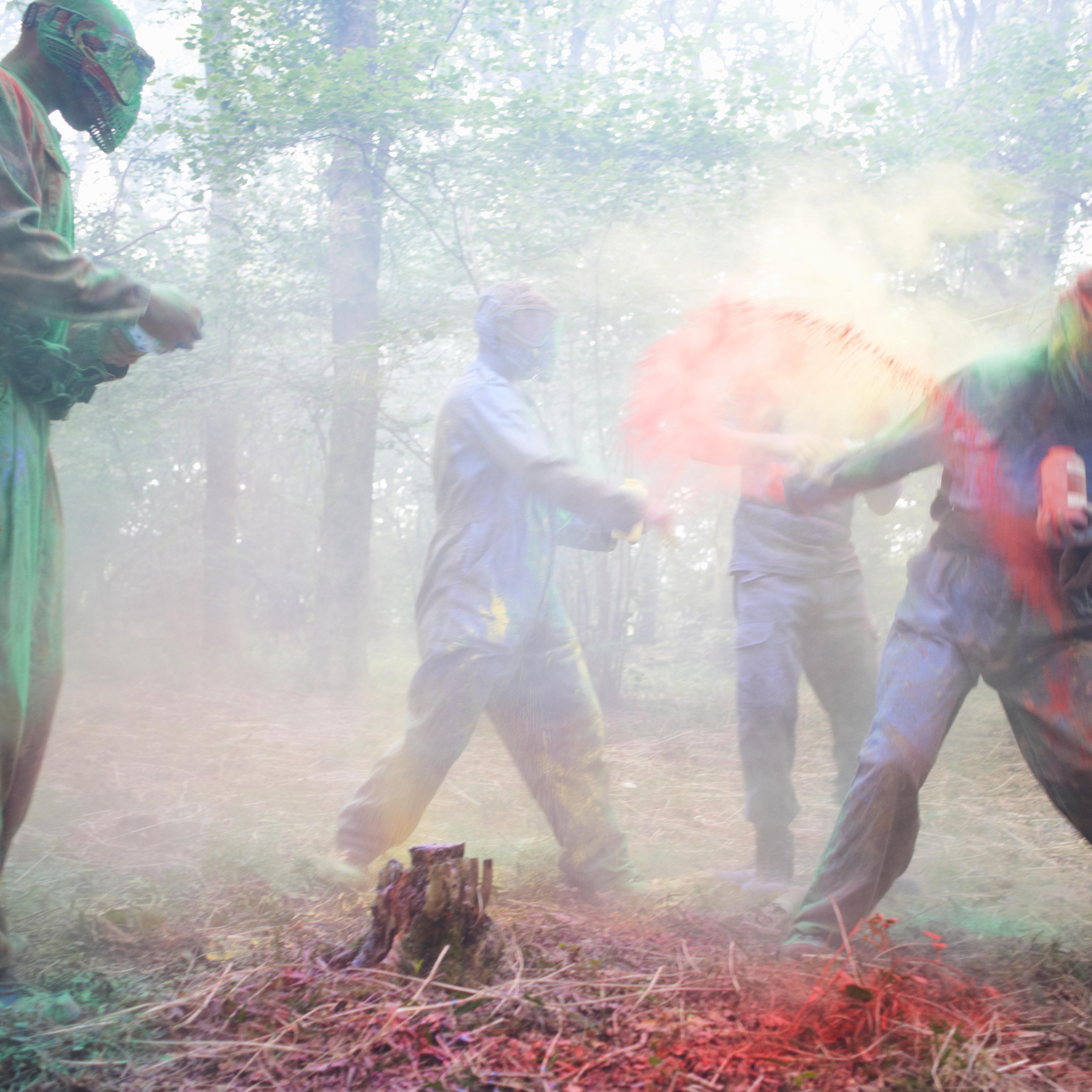 Paintball players in action