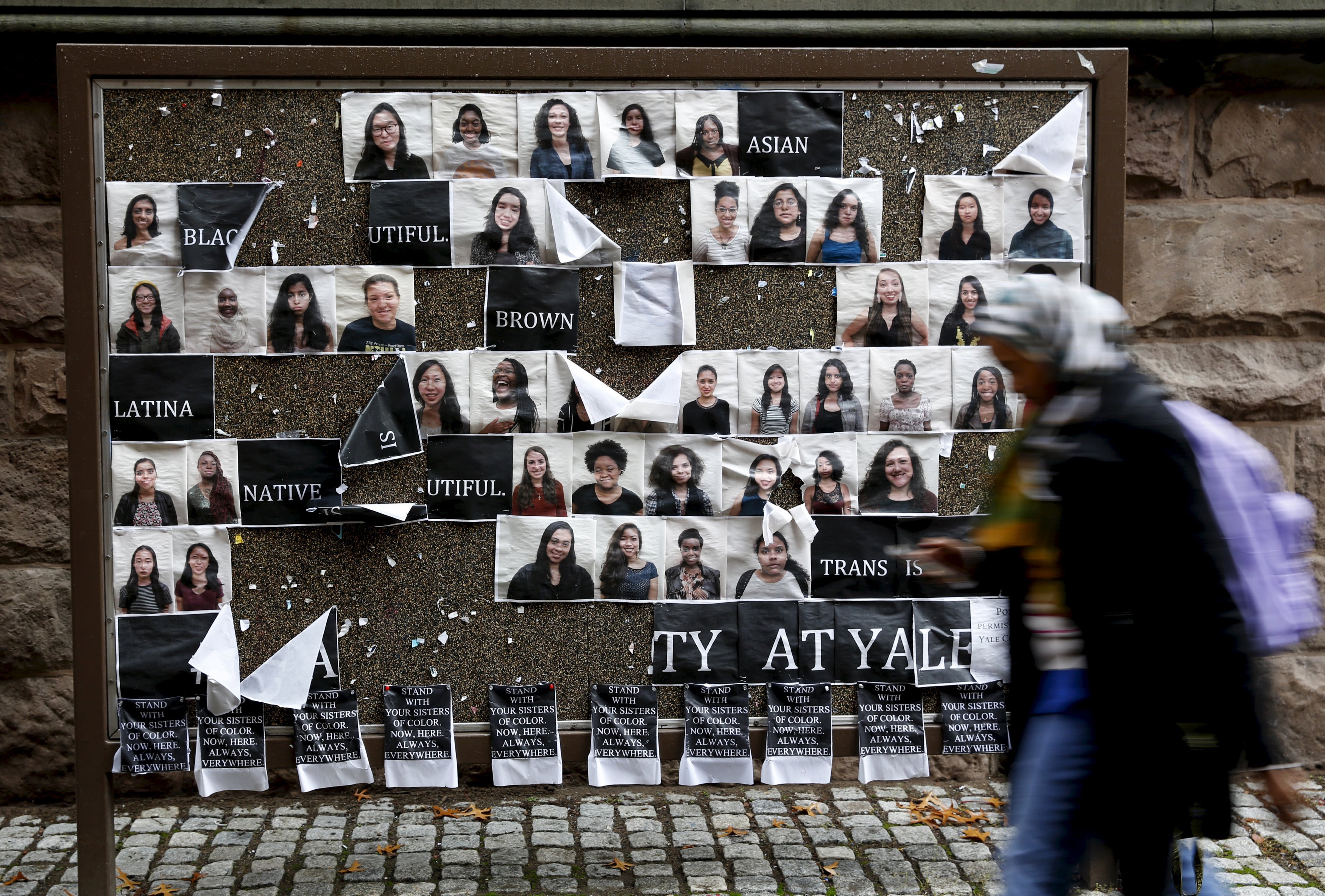 Student walks by a college noticeboard on campus at Yale University in New Haven, Connecticut