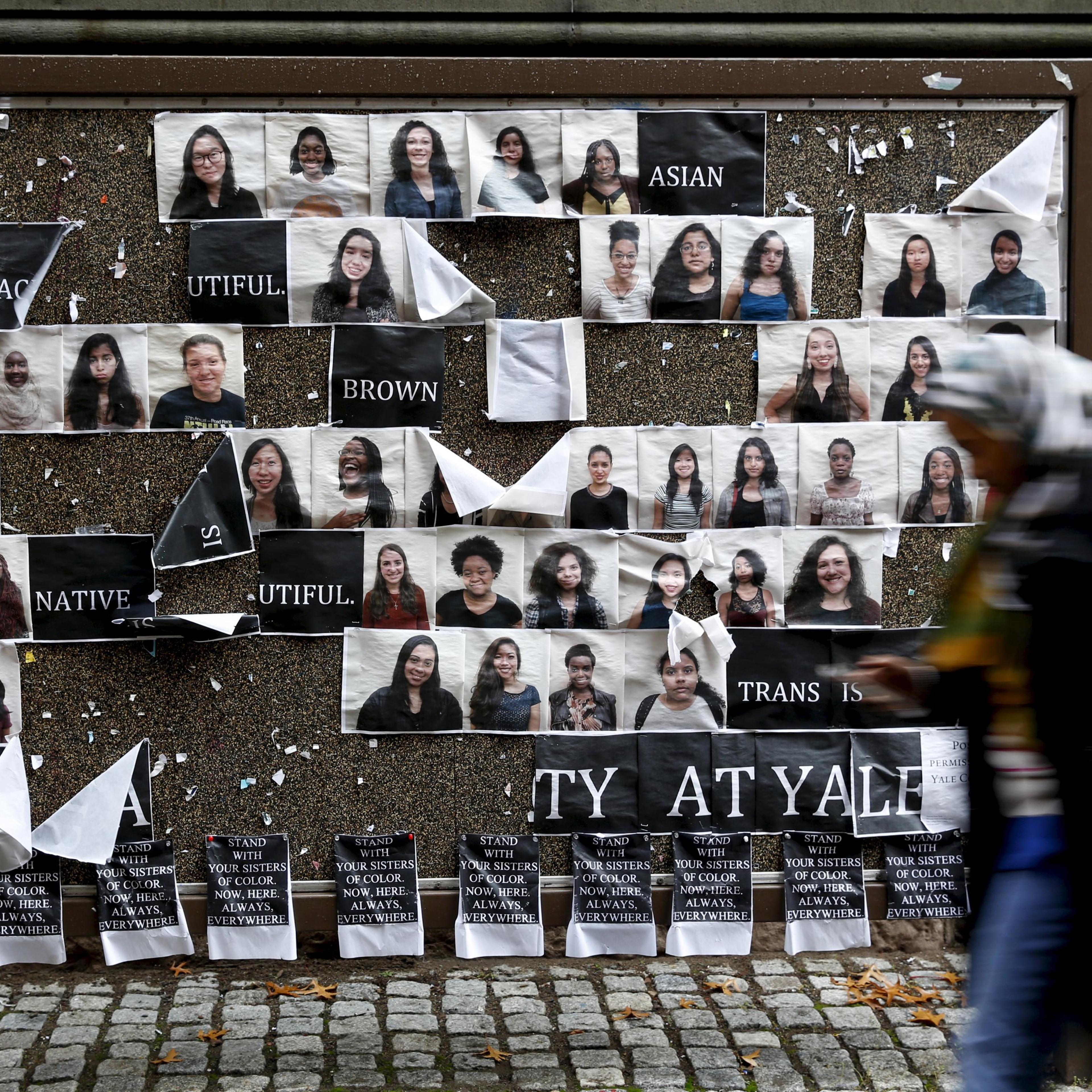 Student walks by a college noticeboard on campus at Yale University in New Haven, Connecticut