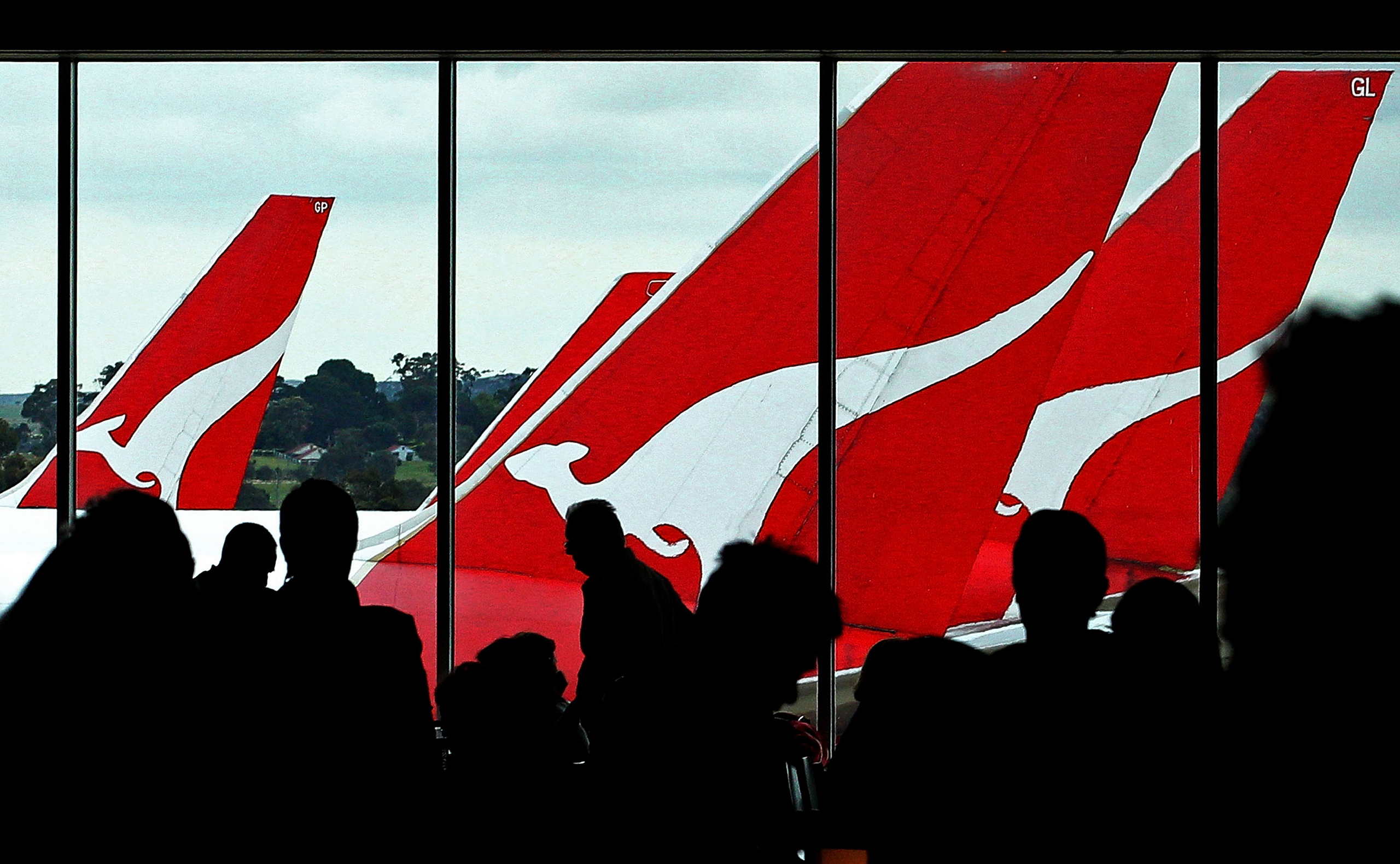 Passengers wait inside the terminal to board their Qantas flights after checking in at Melbourne Airport, Australia, on October 31, 2011.