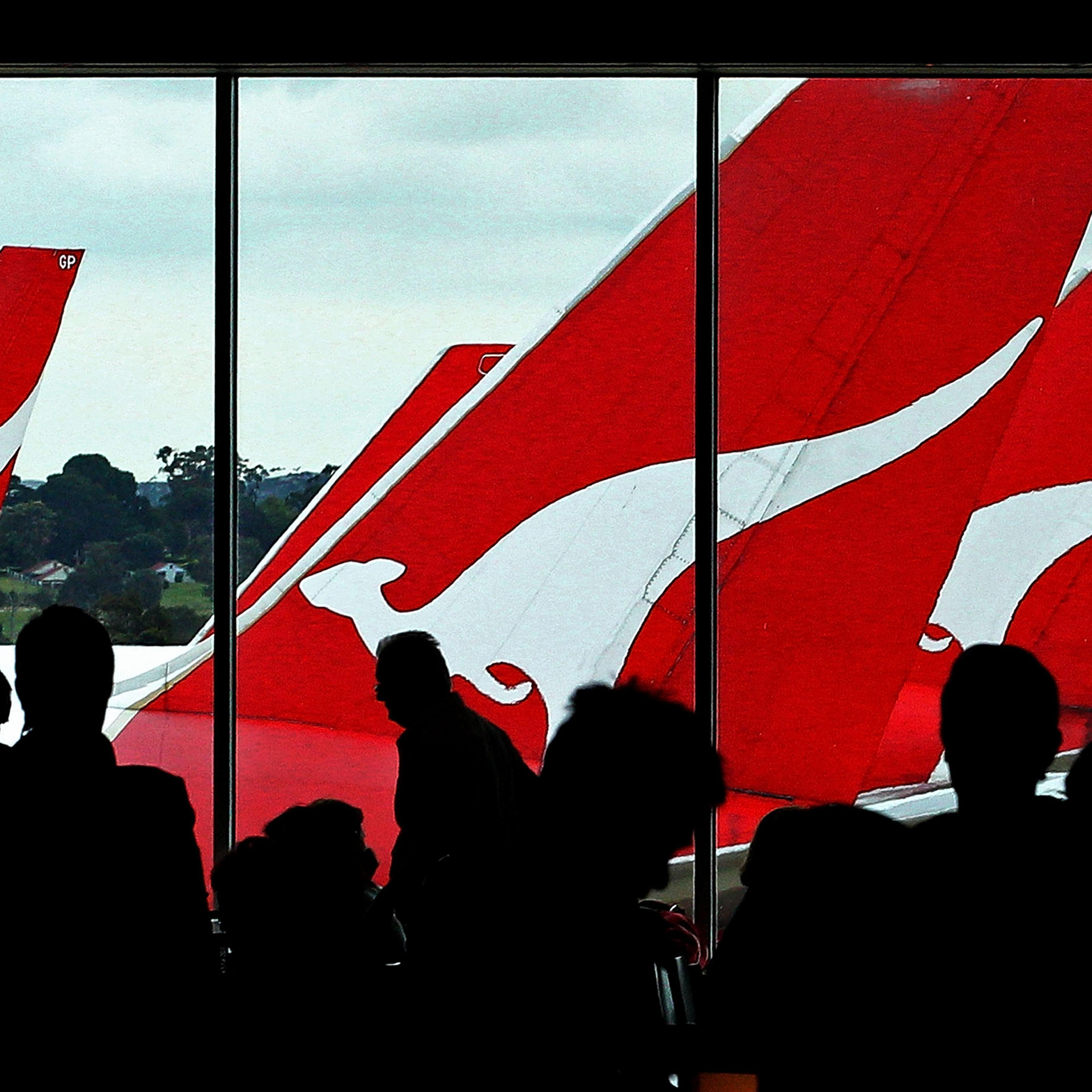 Passengers wait inside the terminal to board their Qantas flights after checking in at Melbourne Airport, Australia, on October 31, 2011.