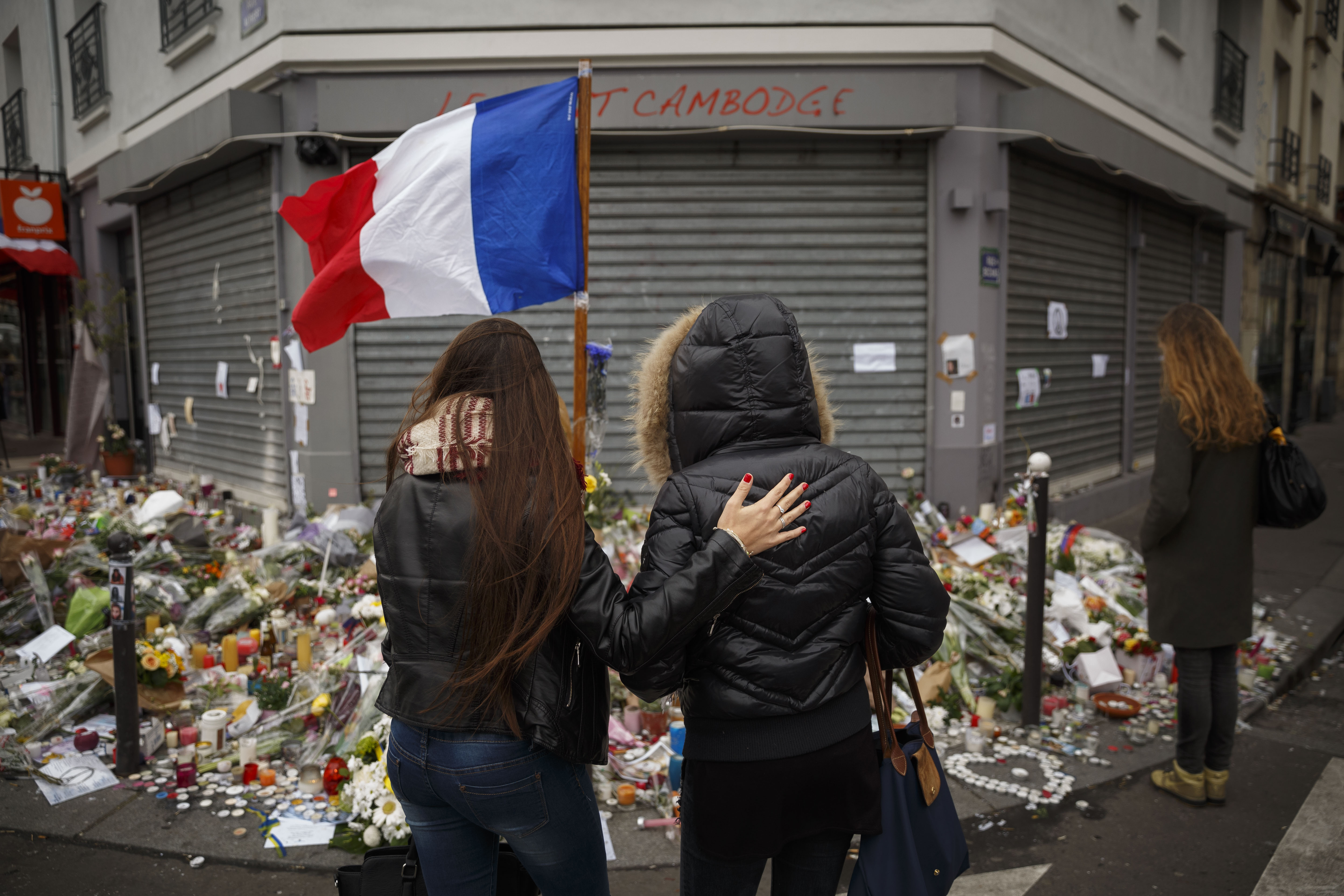 Two women stand outside the Petit Cambodge restaurant, a site of last Friday's attacks, in Paris, on Nov. 17, 2015.