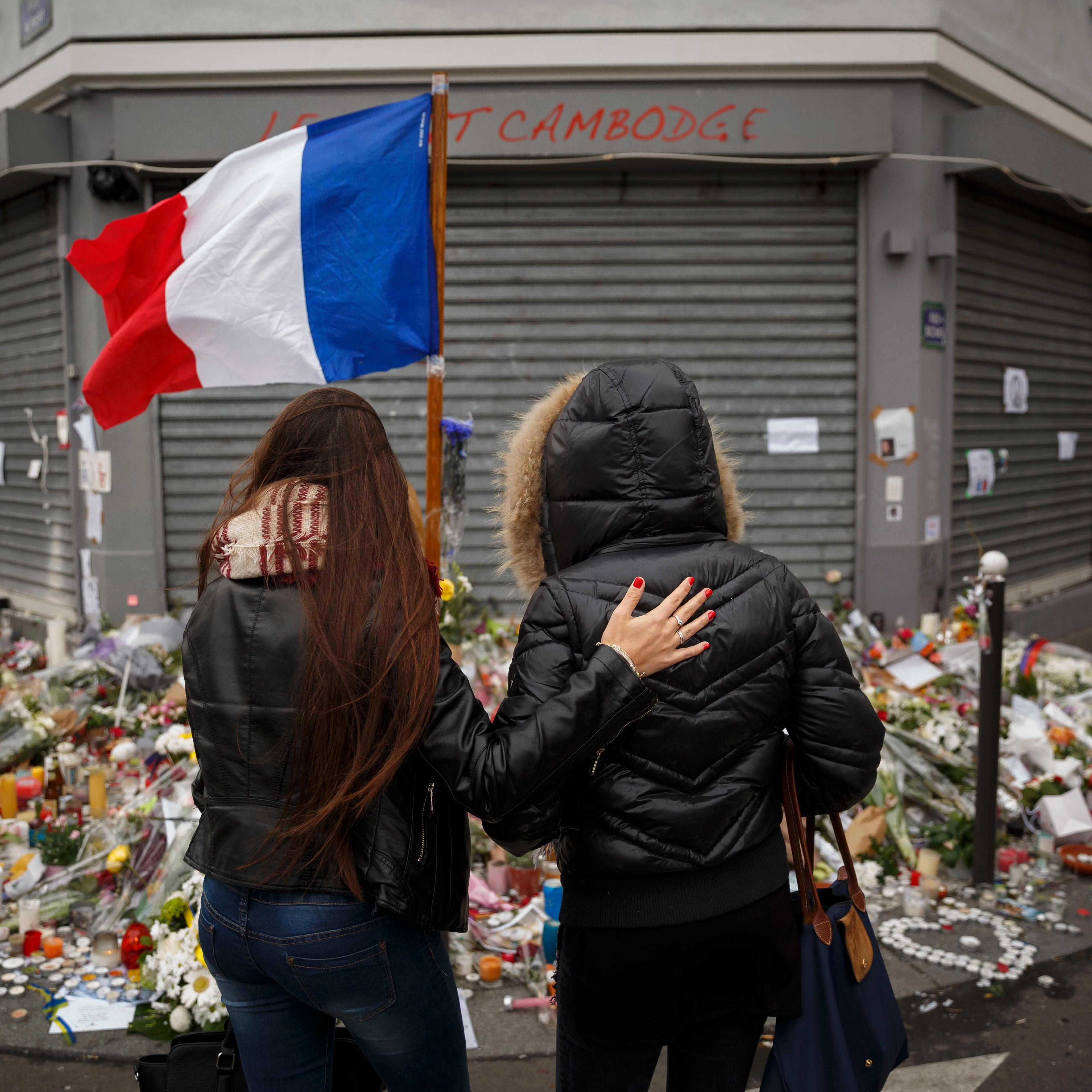 Two women stand outside the Petit Cambodge restaurant, a site of last Friday's attacks, in Paris, on Nov. 17, 2015.