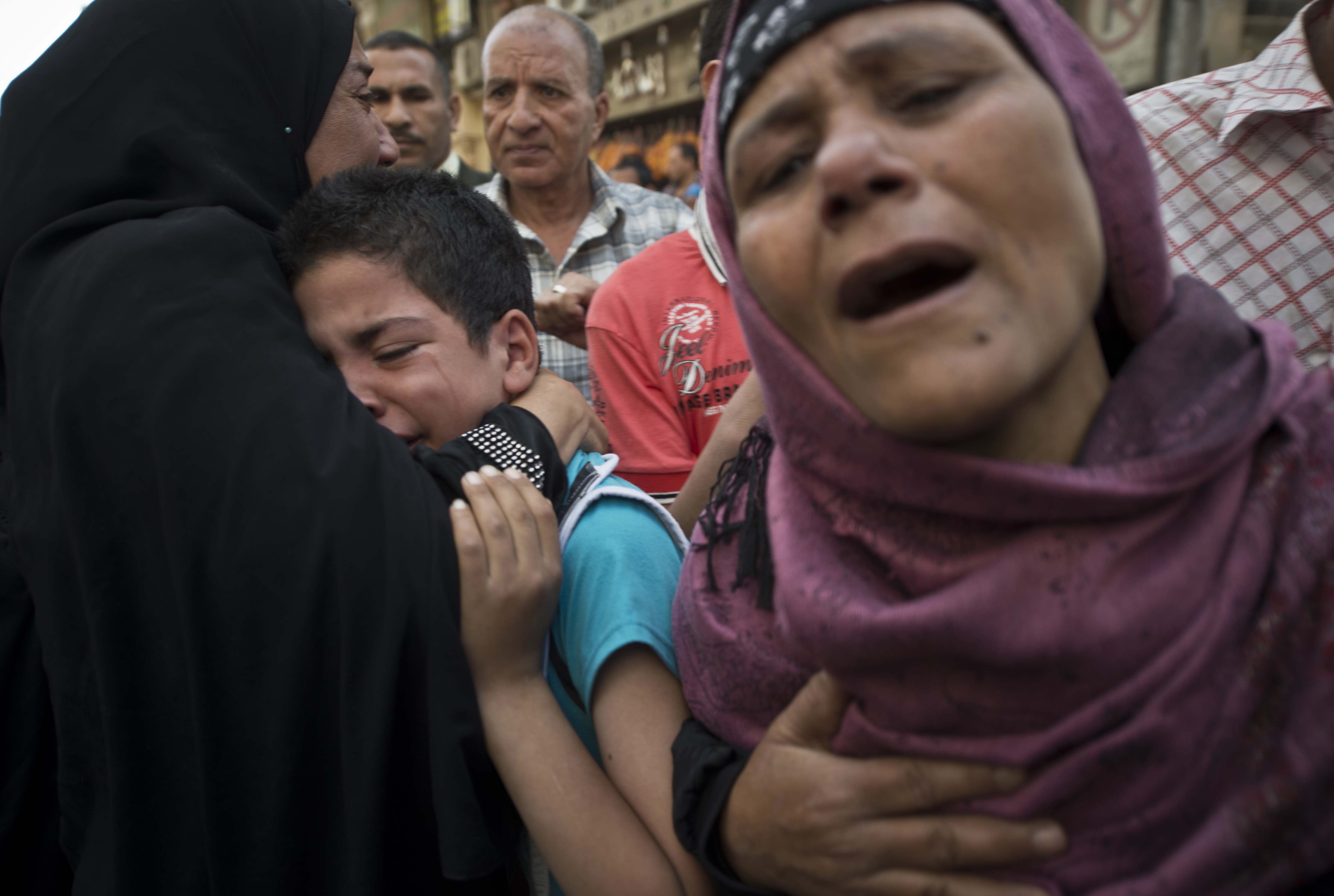 Egyptians react outside the courtroom in the southern province of Minya after an court sentenced Muslim Brotherhood leader Mohamed Badie and other alleged Islamists to death on April 28, 2014.