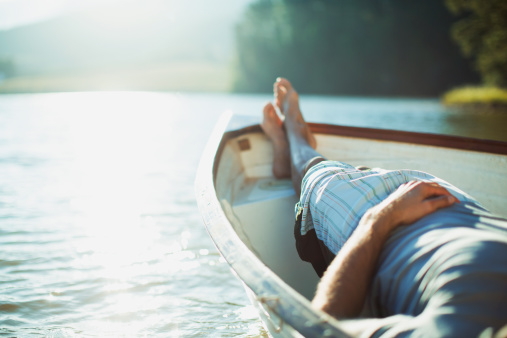 man-resting-rowboat
