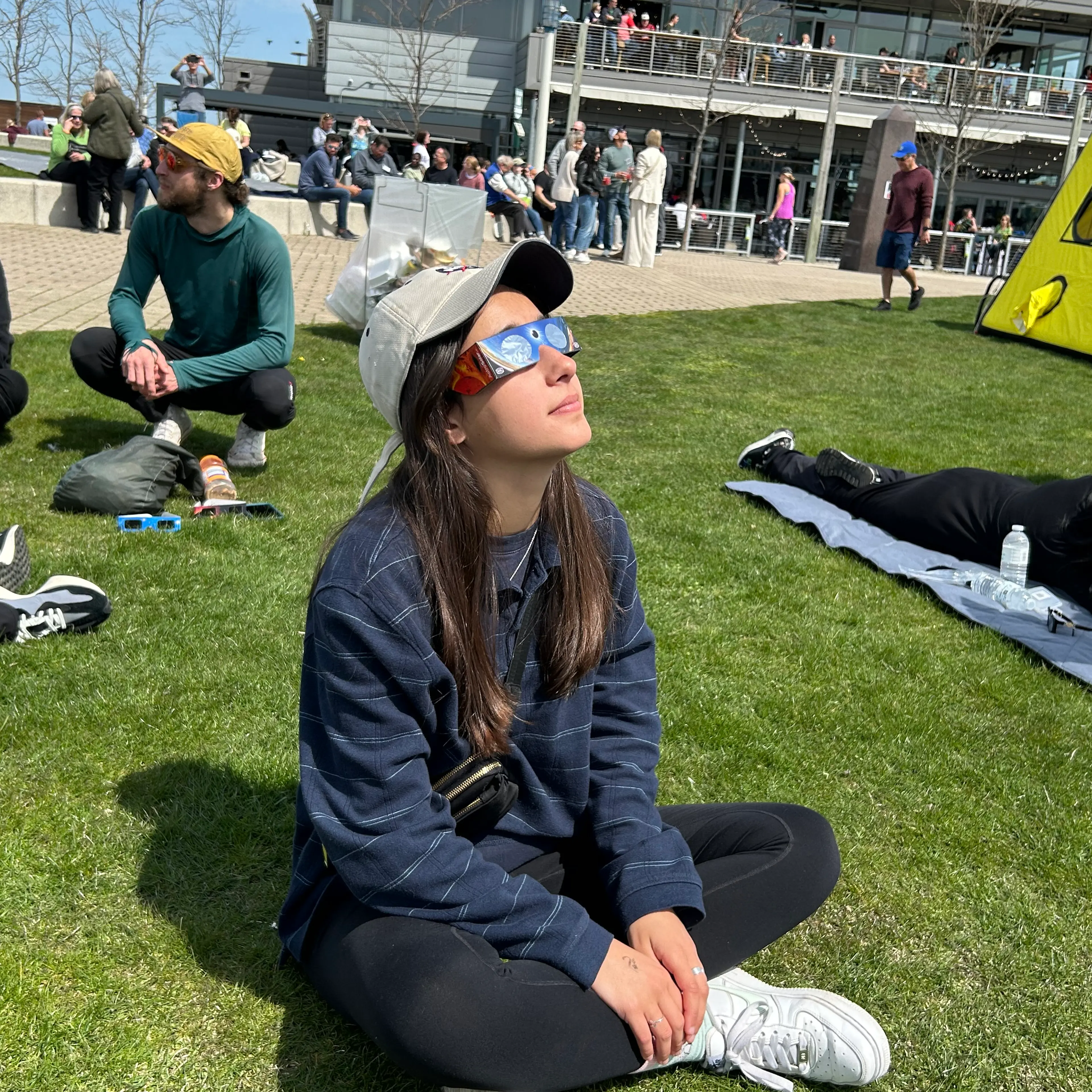 Paloma Kluger, 21, watches the eclipse from the Great Lakes Science Center in Cleveland