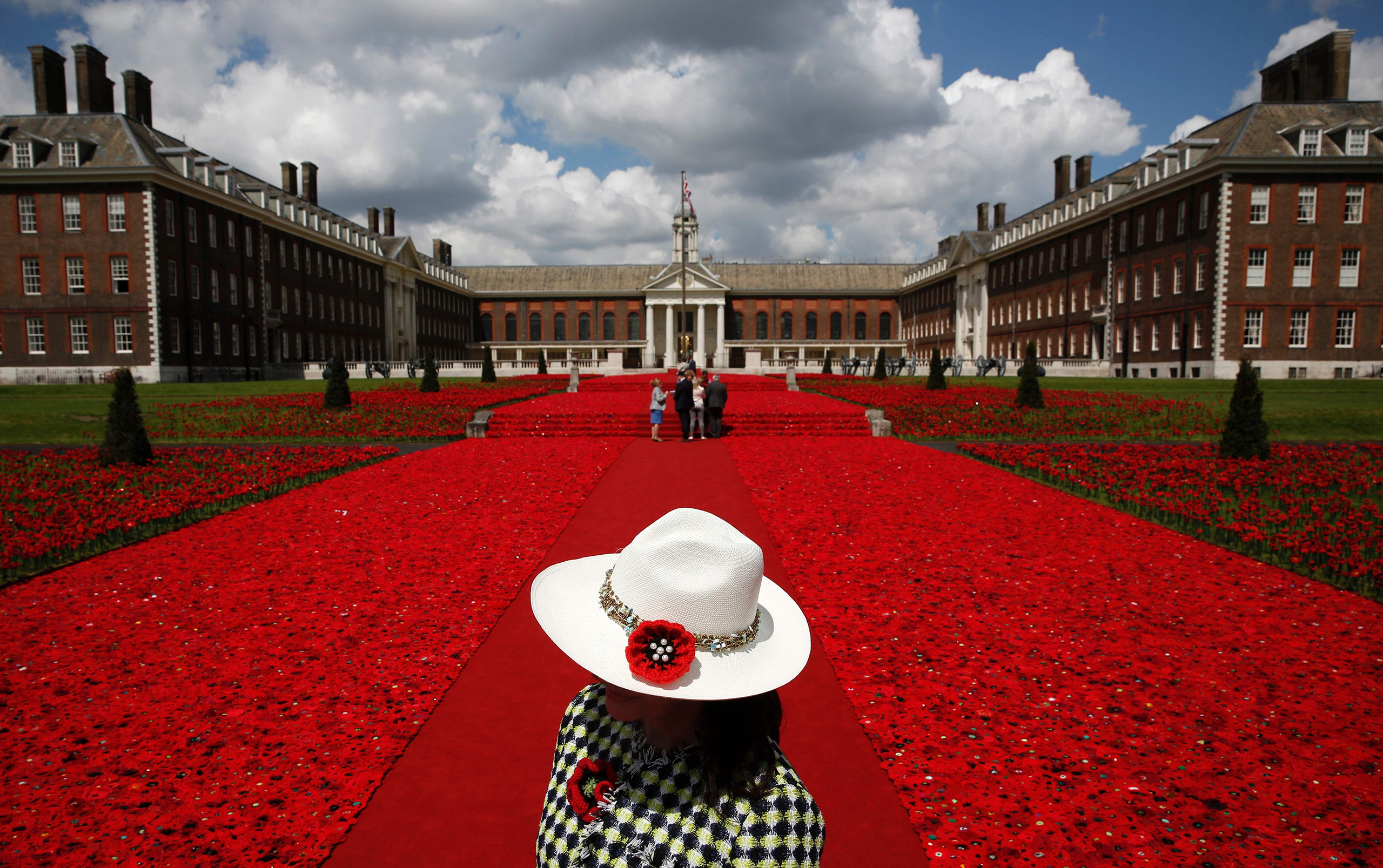 A volunteer stands to the entrance of the 5000 Poppies Garden at the Chelsea Flower Show. Created by Australians Lynn Berry and Margaret Knight, the garden is a tribute to their fathers who both fought in WWII. London, May 23, 2016.