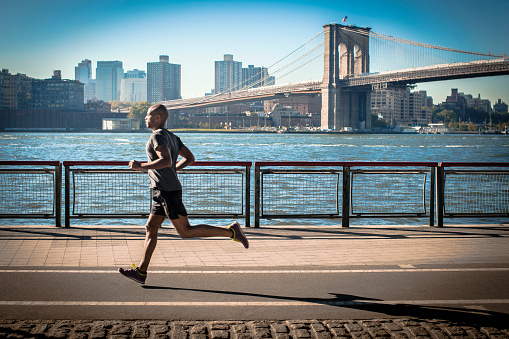 man-running-next-river