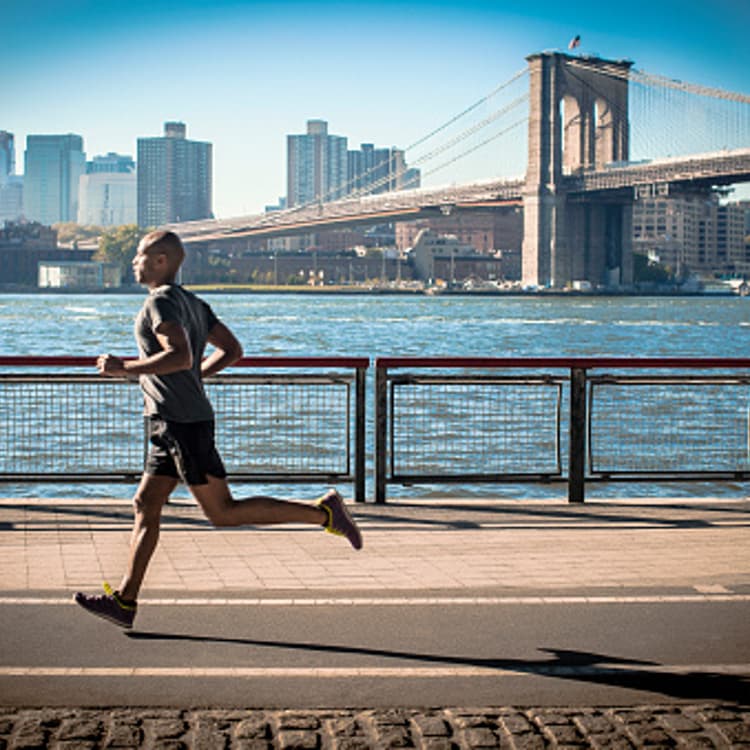 man-running-next-river