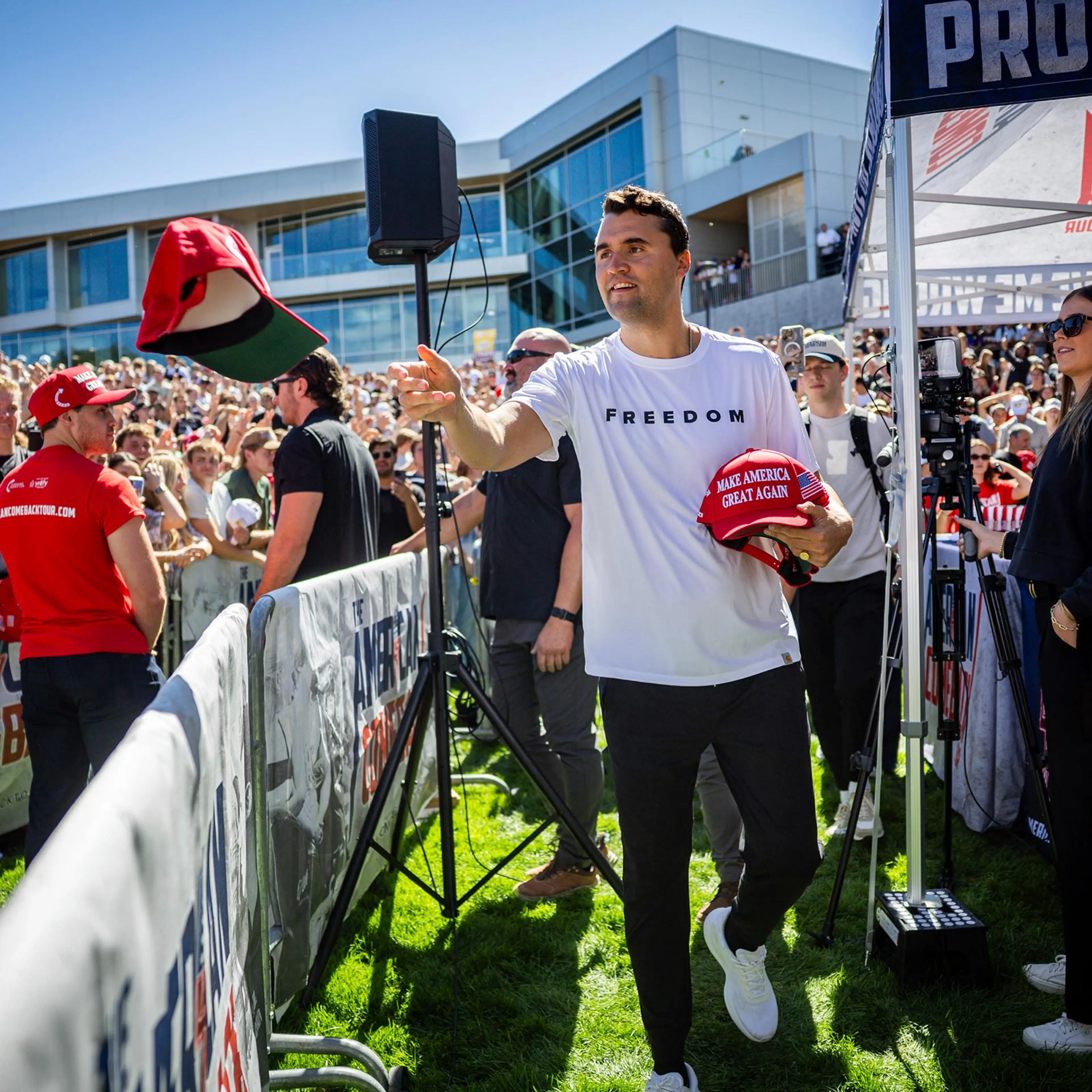 Charlie Kirk hands out hats before speaking at Utah Valley University in Orem, Utah, Wednesday, Sept. 10, 2025.
