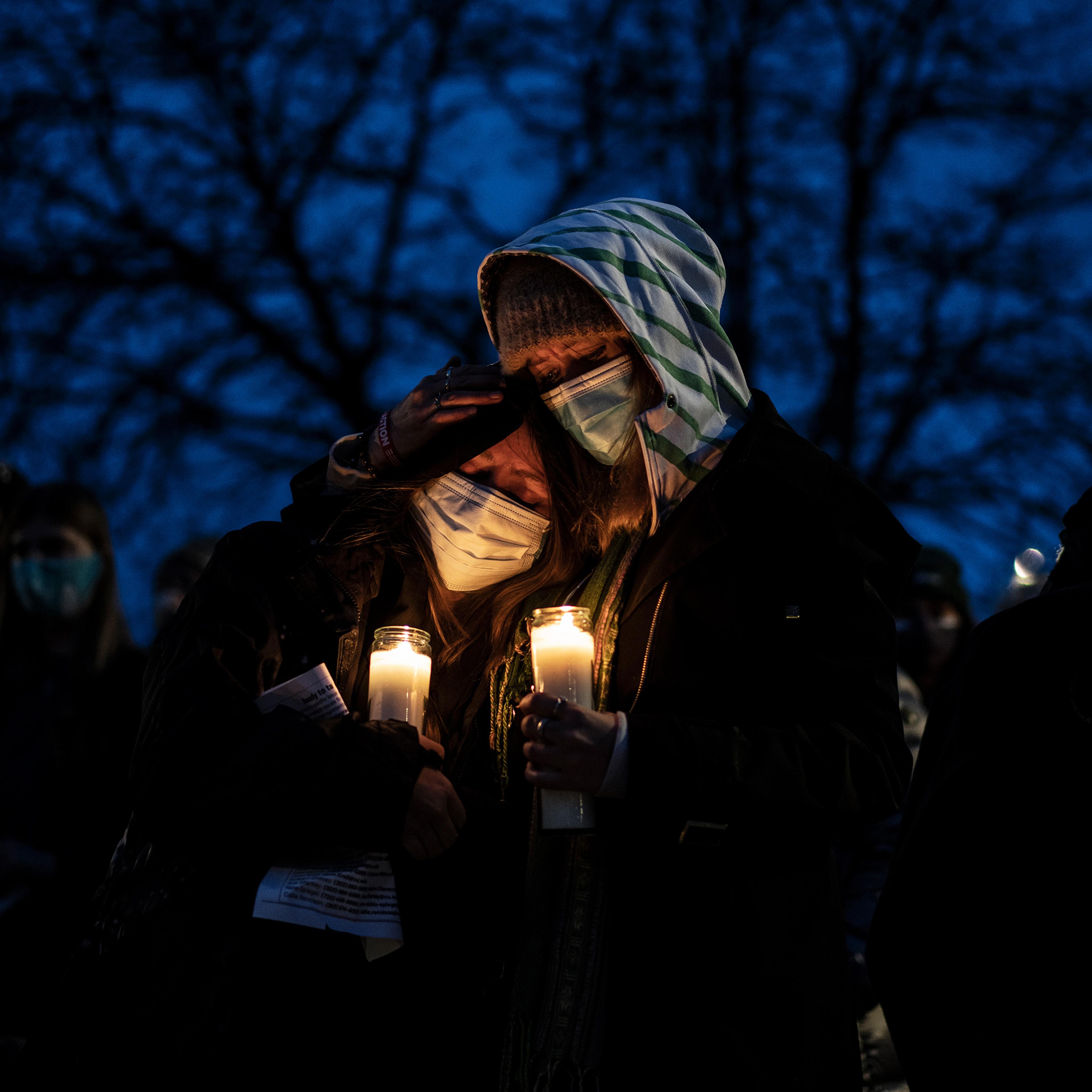 Mourners attend a vigil to commemorate the victims of a mass shooting at a King Soopers grocery store in Boulder, C., on March 25, 2021.