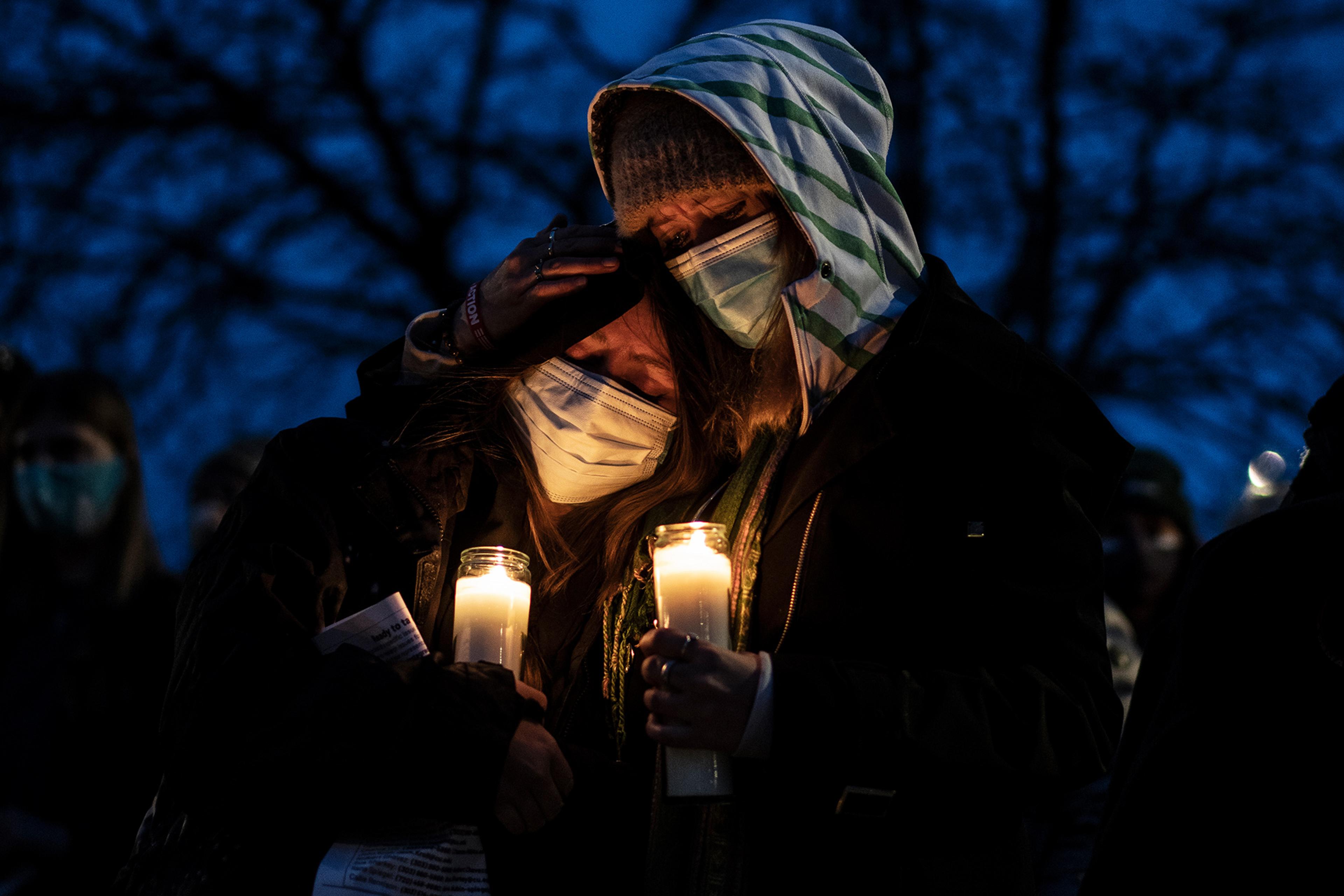 Mourners attend a vigil to commemorate the victims of a mass shooting at a King Soopers grocery store in Boulder, C., on March 25, 2021.
