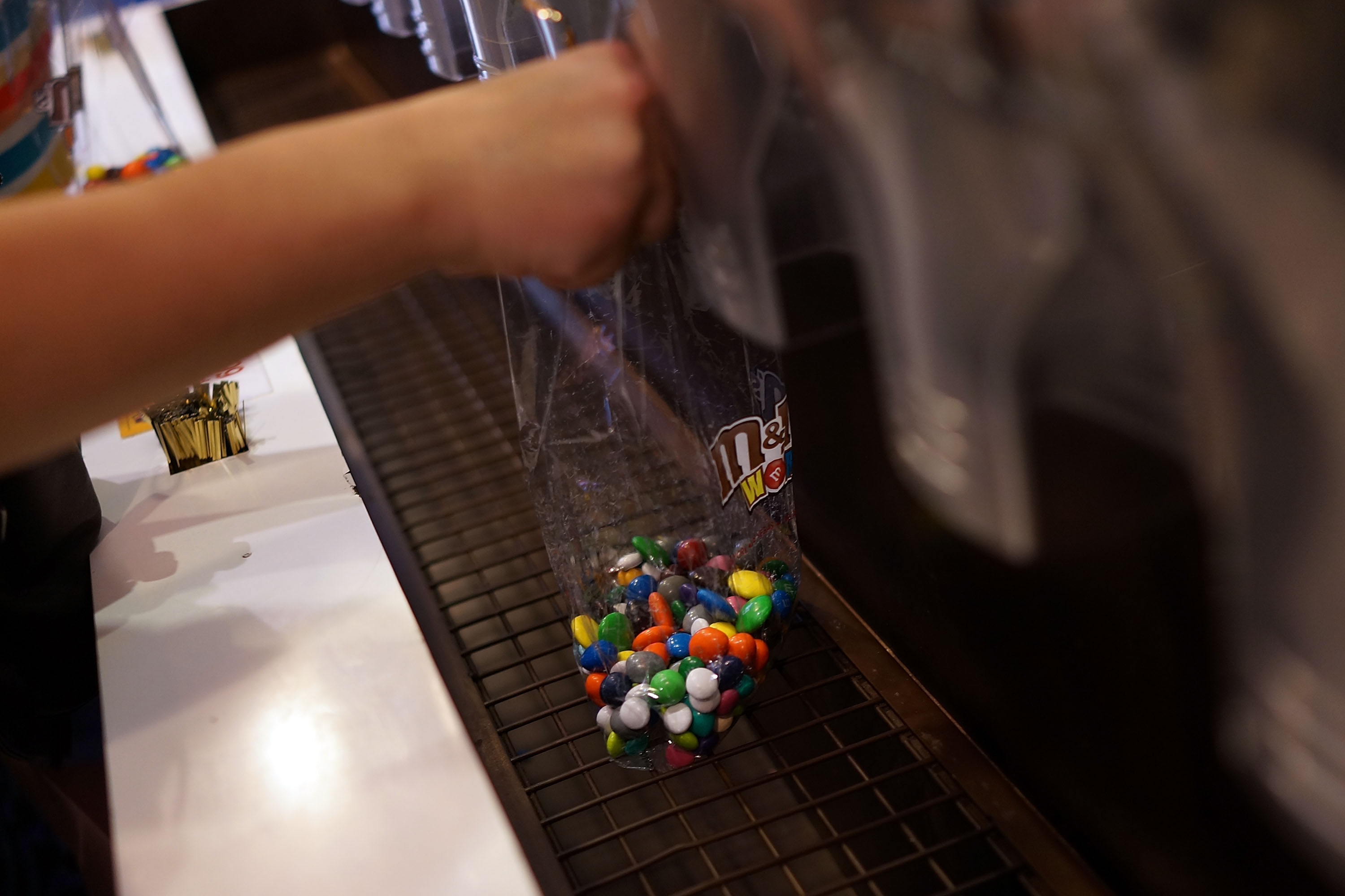People fill up bags of M&amp;M's at the M&amp;M store in Times Square in New York City on July 24, 2014.