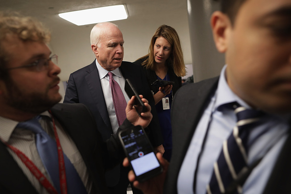 Sen. John McCain (R-AZ) talks with reporters while heading to the weekly Republican Democratic policy luncheon at the U.S. Capitol May 17, 2016 in Washington, DC.