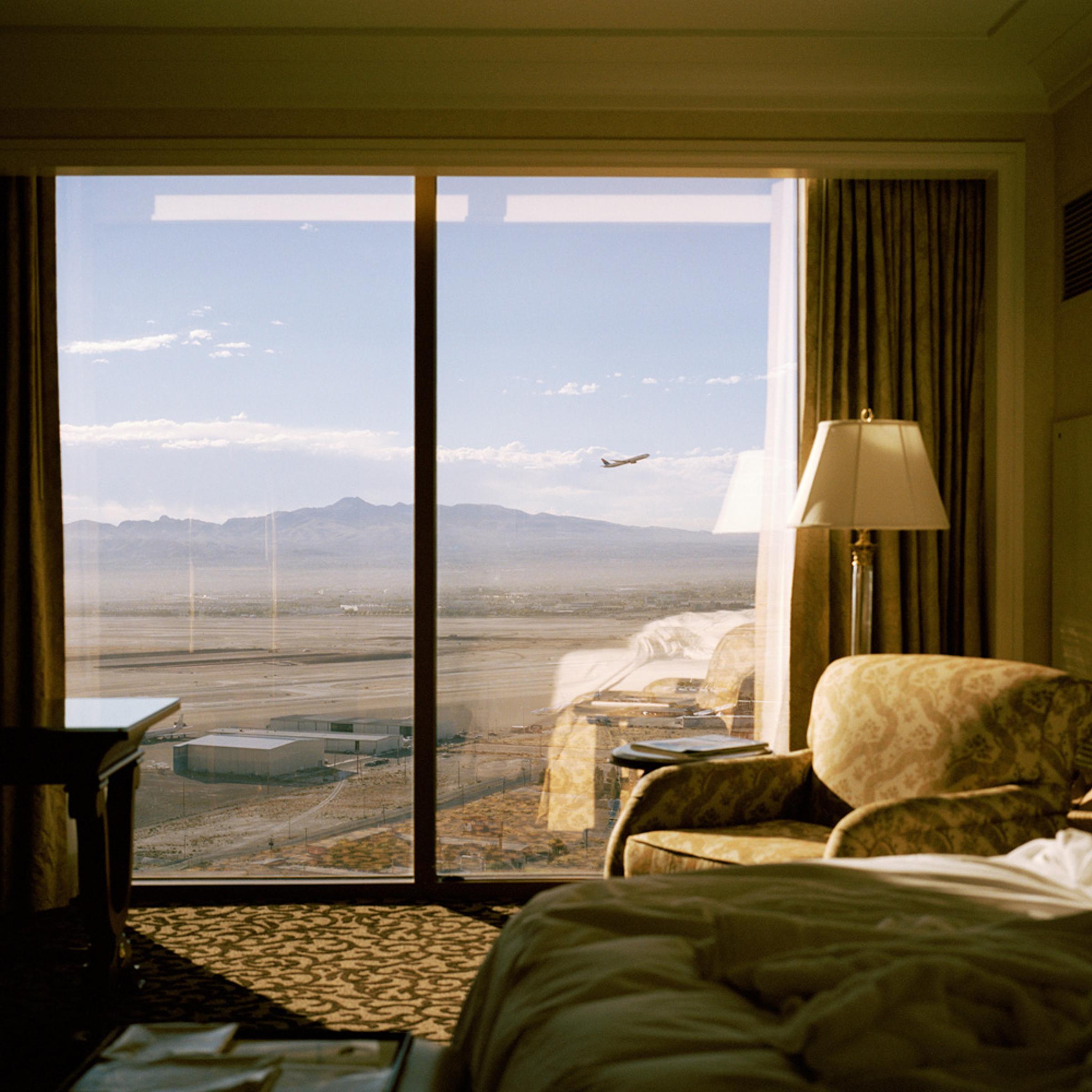 <b>Plane, Las Vegas, Nevada, 2007</b><br />
</br><i>Curator Andy Adams of Flak Photo asked each photographer 'Why did you photograph this place?'</i></br><br />
</br>"This image was taken in Las Vegas. It was one of those images that I had to take; it really jumped out at me. I was away working staying in this hotel, I woke up early the morning I was due to leave and came out of the bathroom where this scene was all laid out. I took two photographs from the same position, one with and one without the plane. For me it says so much about our relationship with the landscape and how we as humans stake our claim on the world and alter it for our own gains. Vegas is the ultimate artificial landscape and I like this alternative view, more intimate, the other side of the facade."