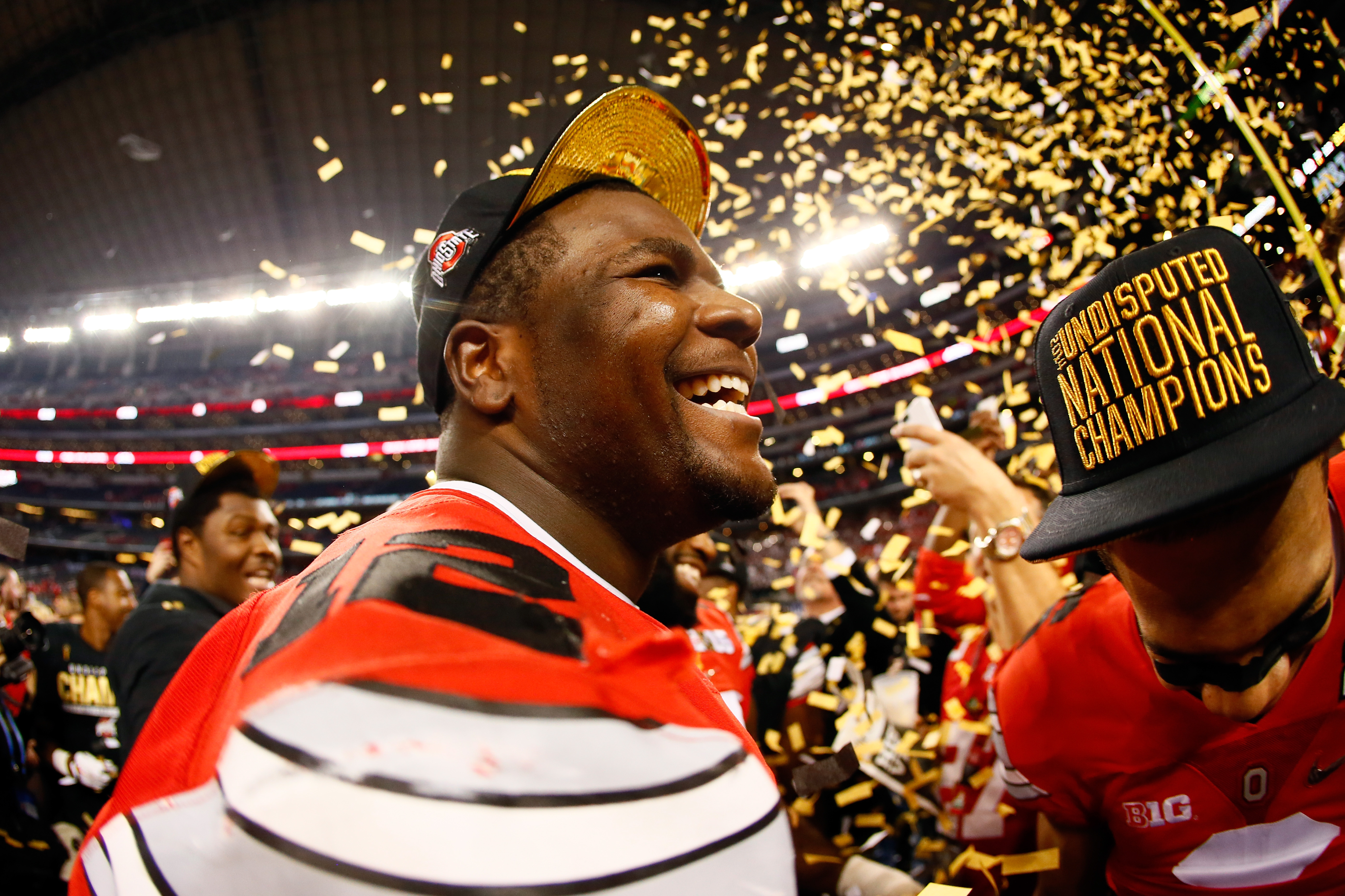 Quarterback Cardale Jones #12 of the Ohio State Buckeyes celebrates after defeating the Oregon Ducks 42 to 20 in the College Football Playoff National Championship Game.