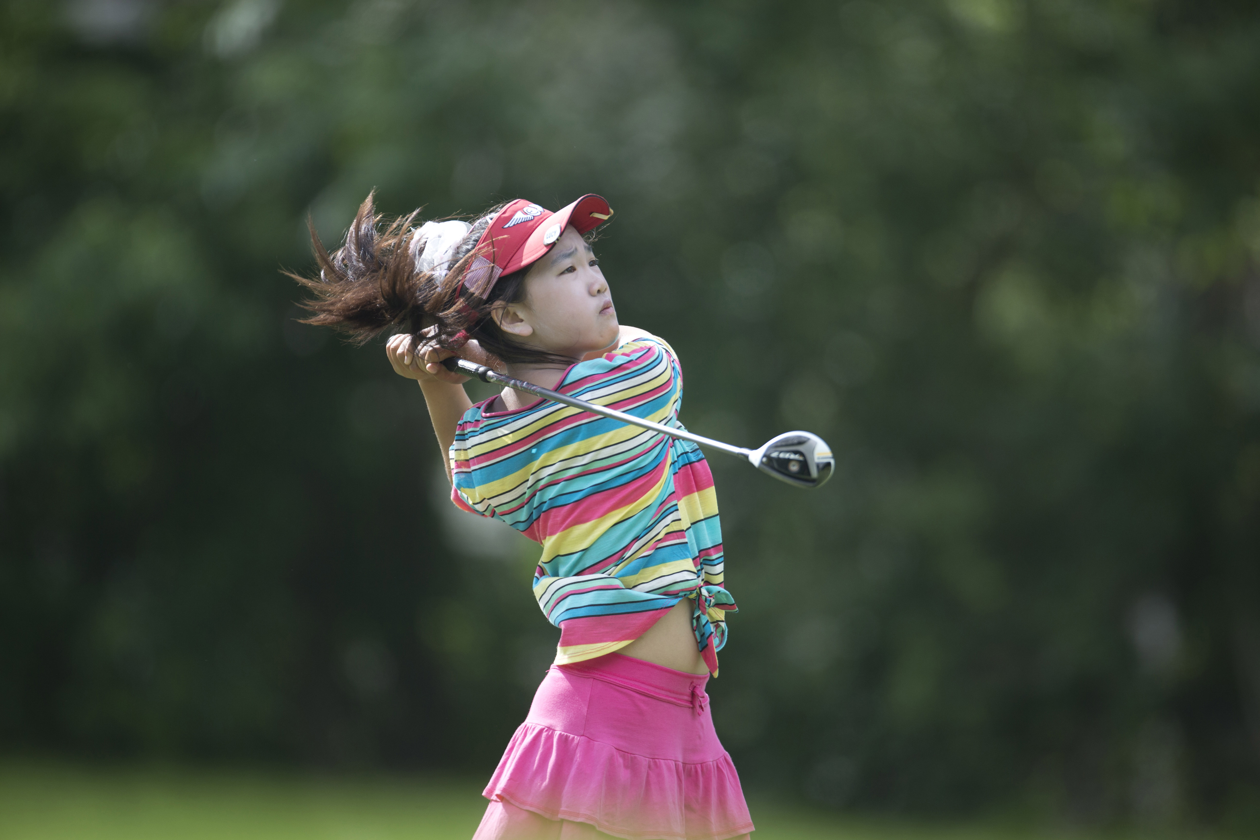 This photo provided by the USGA shows Lucy Li hitting a tee shot on the sixth hole during the first round of the 2013 U.S. Women's Public Links golf event in Norman, Okla, June 19, 2013.