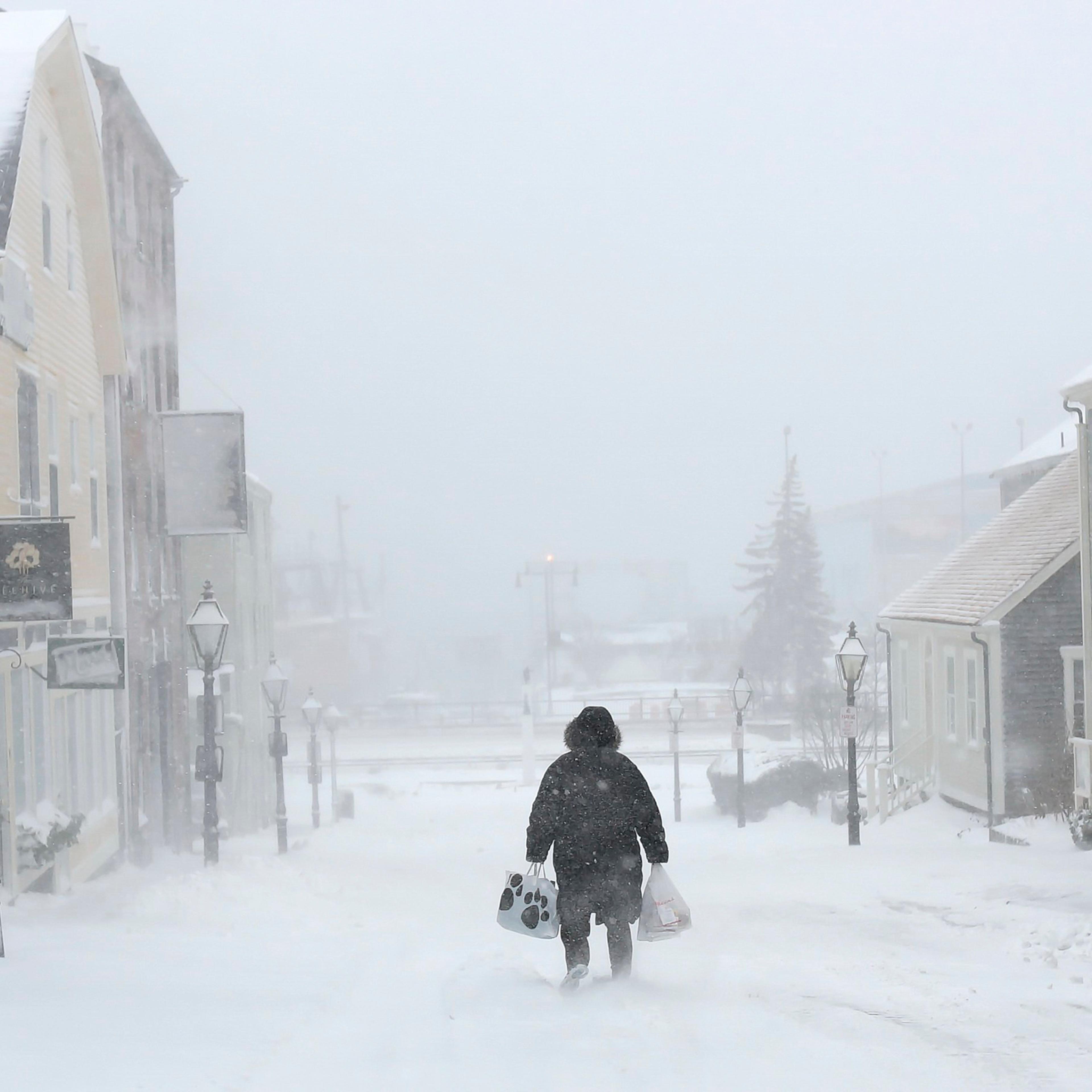 A woman walks down the street during a snowstorm in New Bedford, Mass., on Feb. 8, 2016.