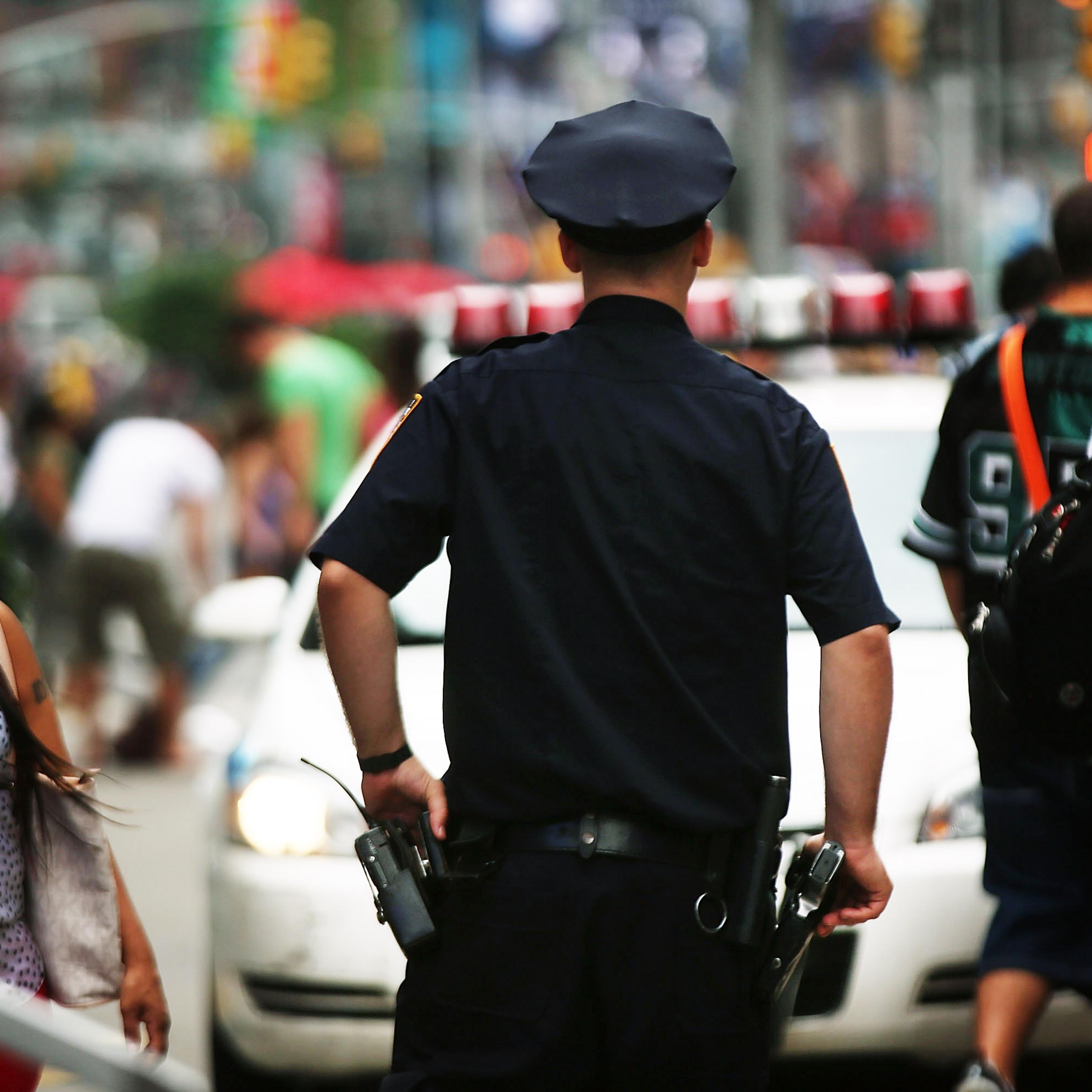 A New York City police officer stands in Times Square on Aug. 12, 2013 in New York City.