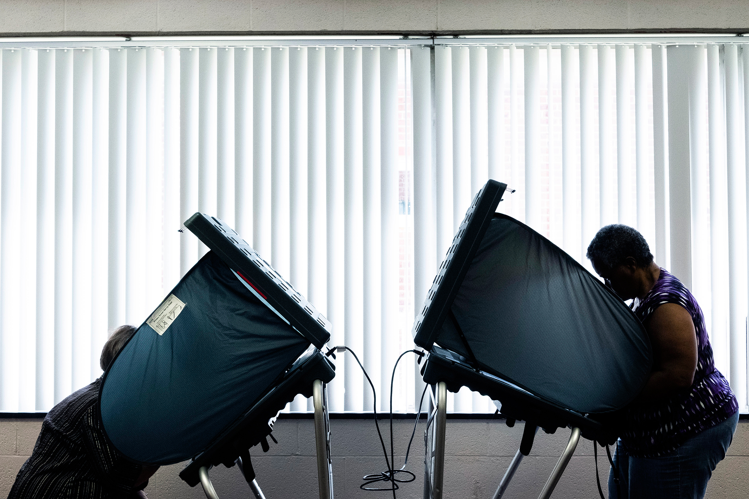 Voters cast their ballots in a polling station in Lexington, Ky., on May 22, 2018.