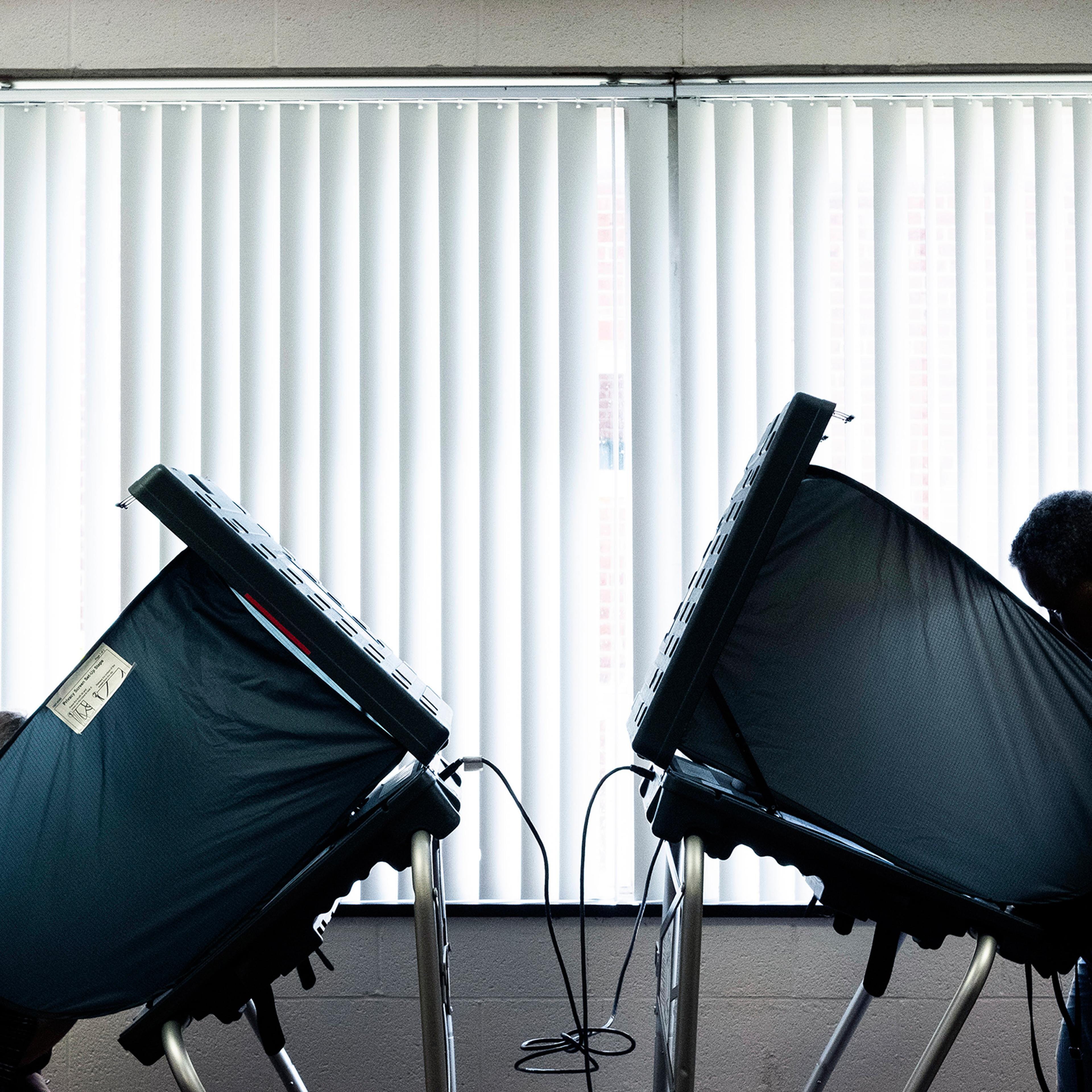 Voters cast their ballots in a polling station in Lexington, Ky., on May 22, 2018.