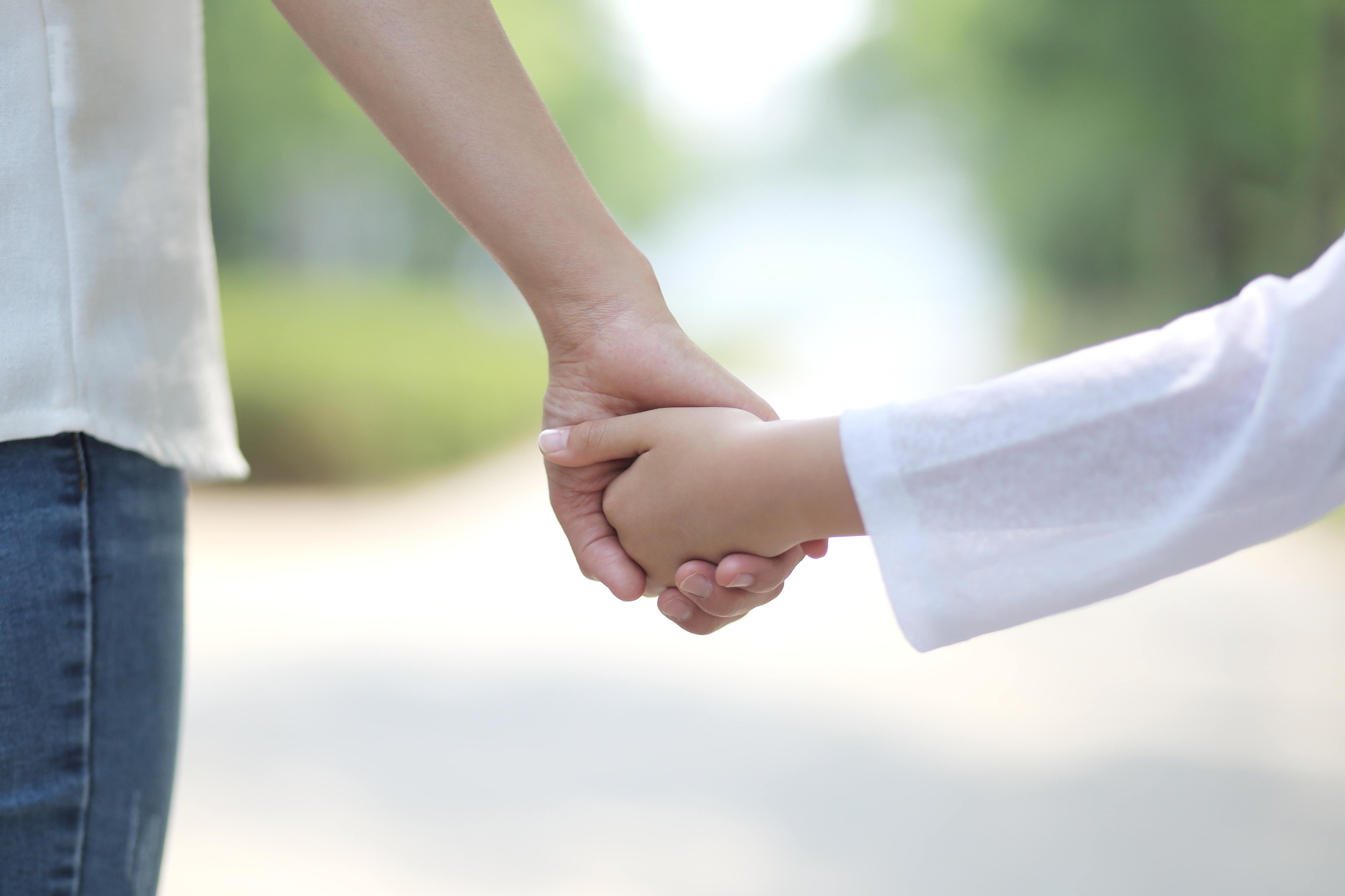 Mother walking hand in hand with her daughter