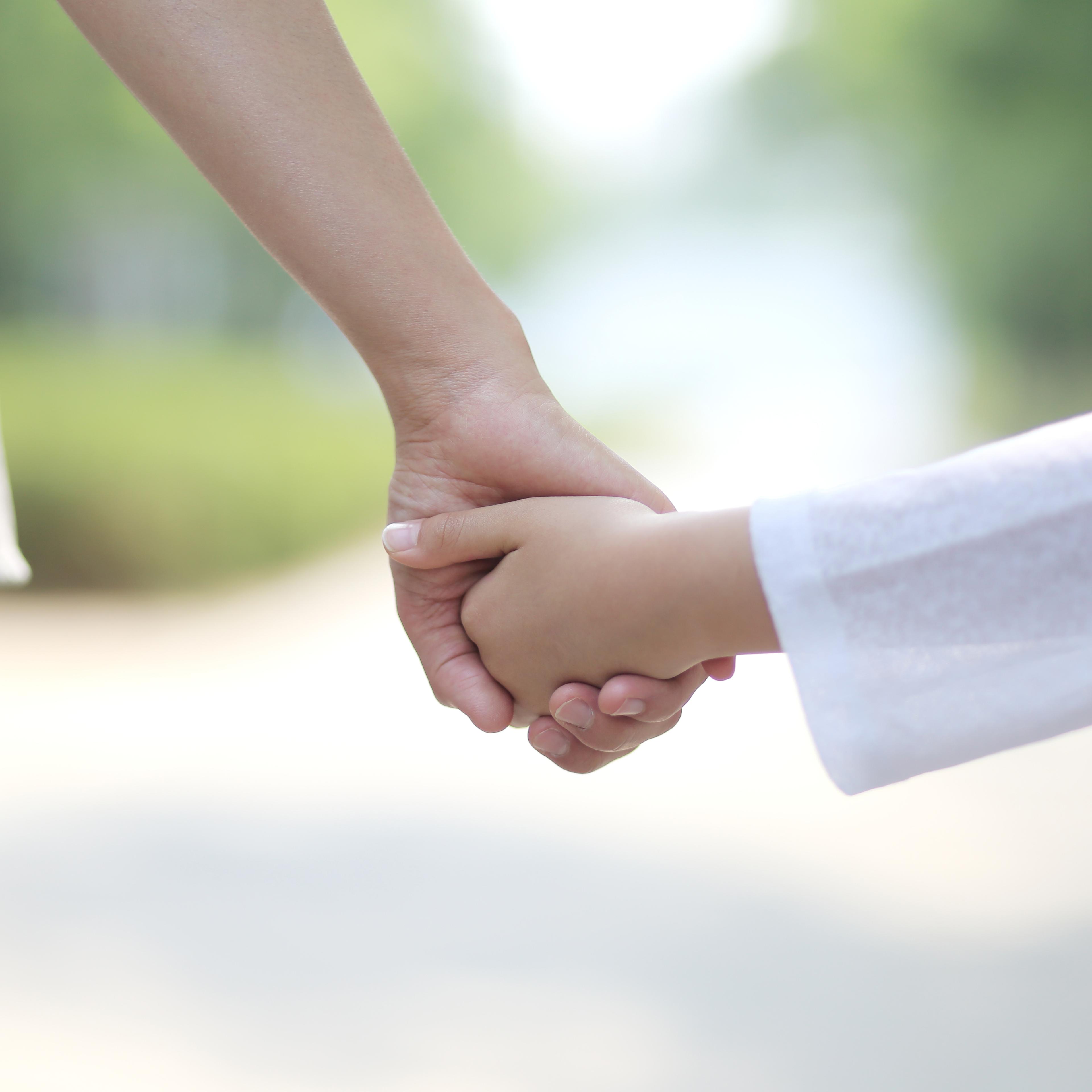 Mother walking hand in hand with her daughter